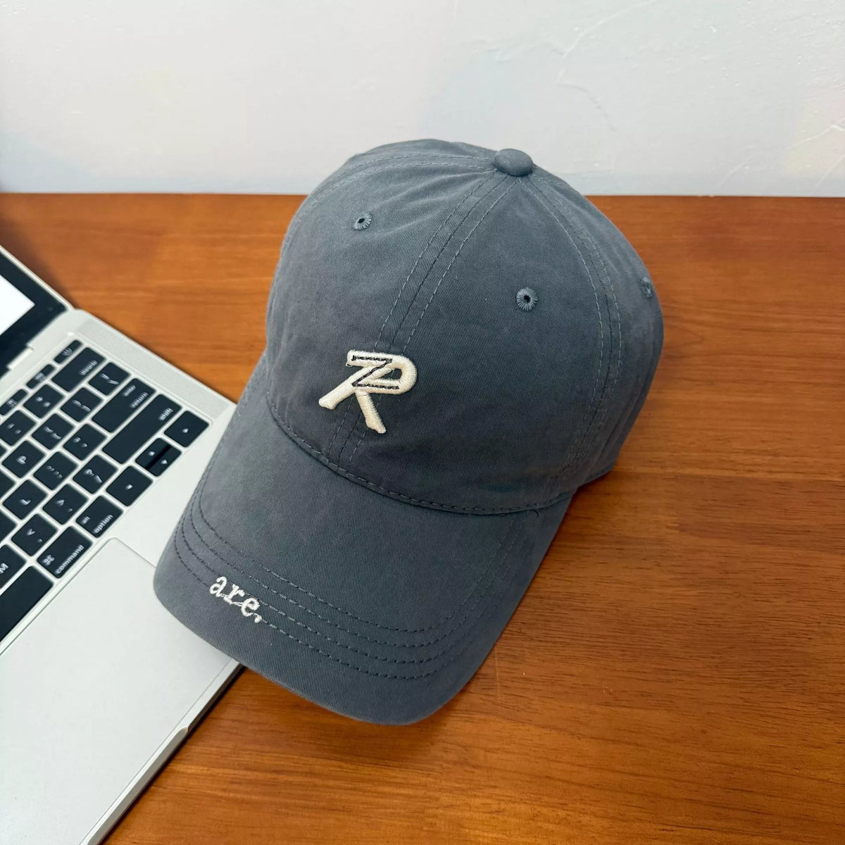 Letter embroidered baseball cap in navy blue, front view