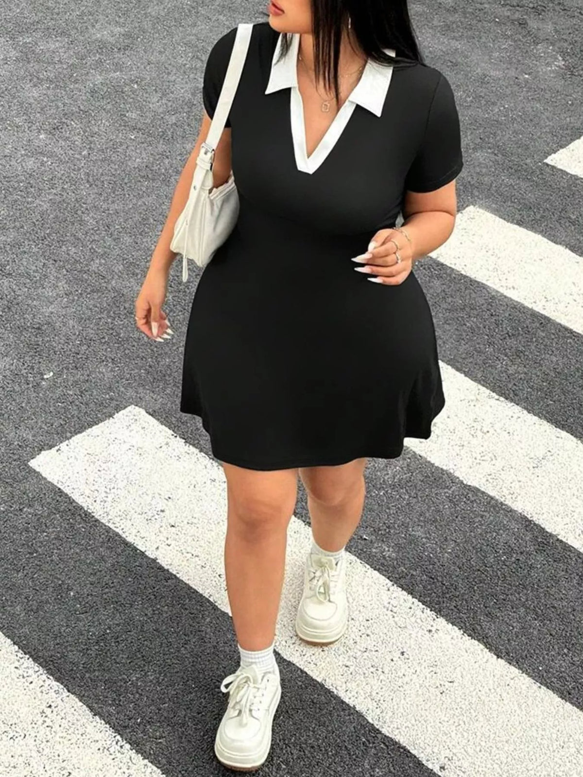 Black bodycon mini dress showing contrast collar detail
