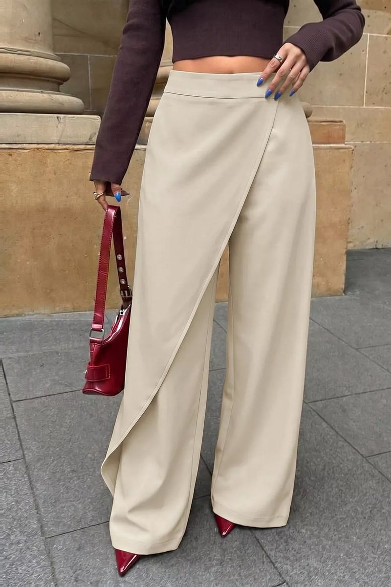 Asymmetrical wrap wide leg pants in beige worn with a fitted knit and heels
