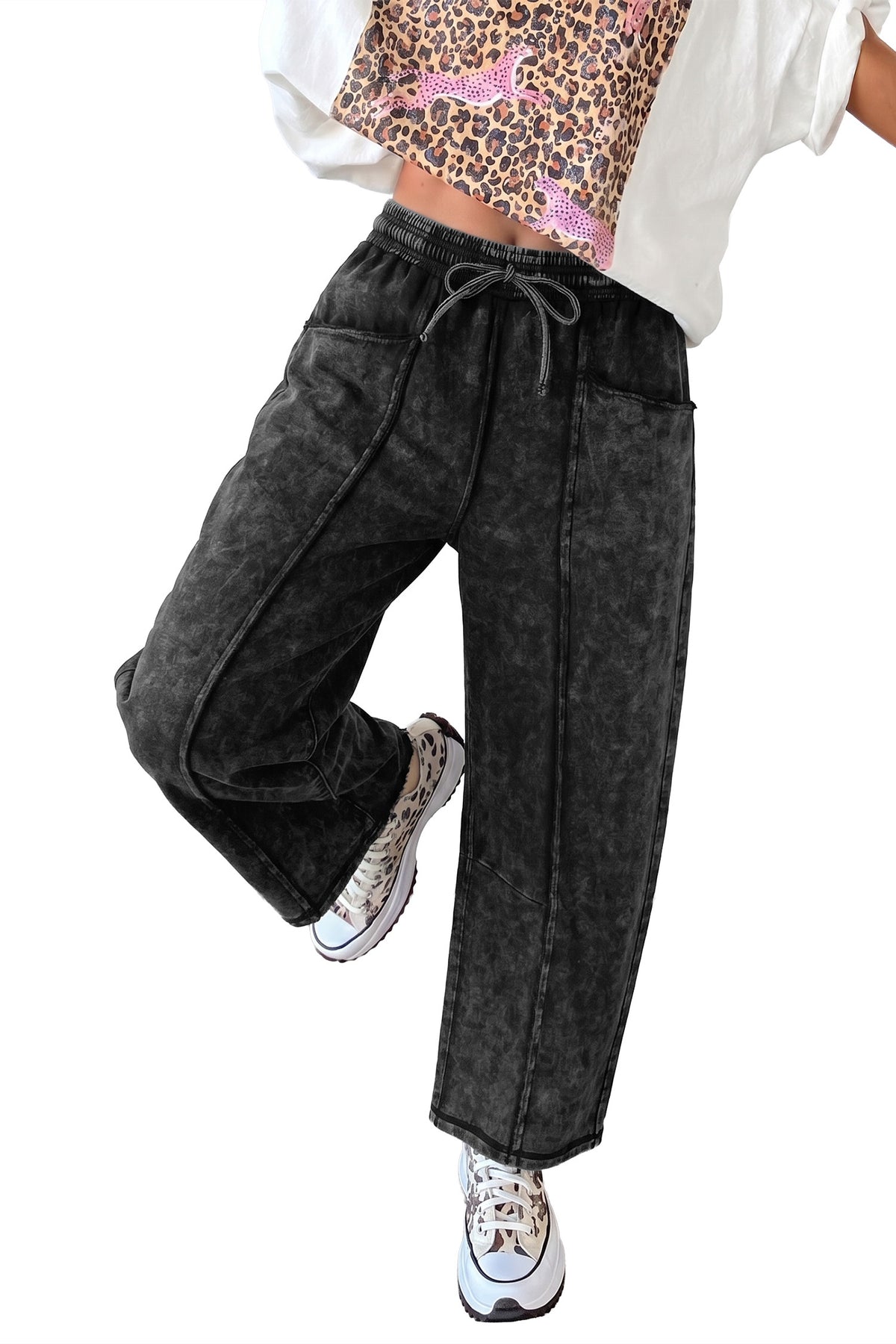 Black mineral wash barrel pants close up of raw seam and patch pocket detail