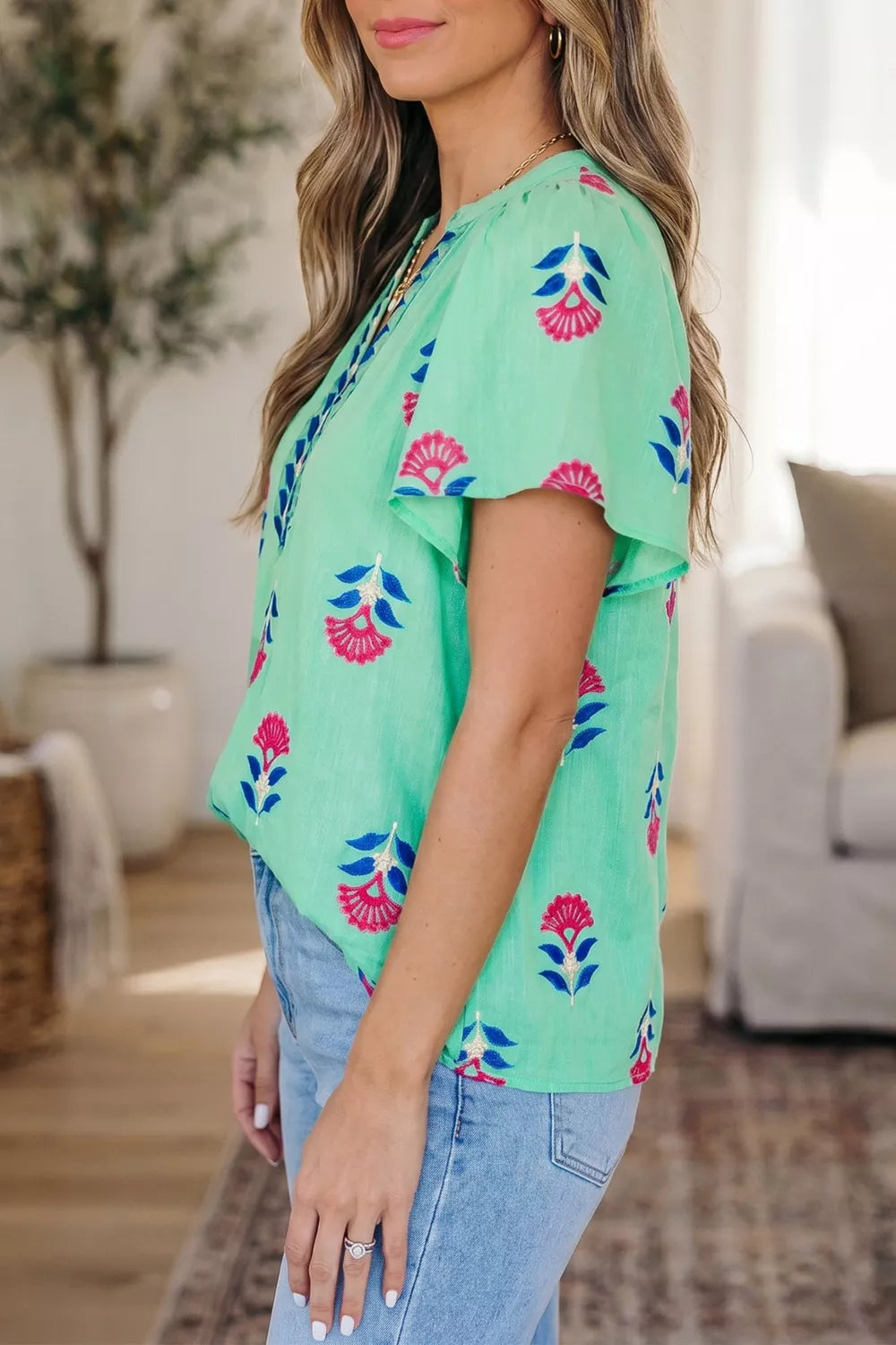 Turquoise floral V neck flutter sleeve blouse side view