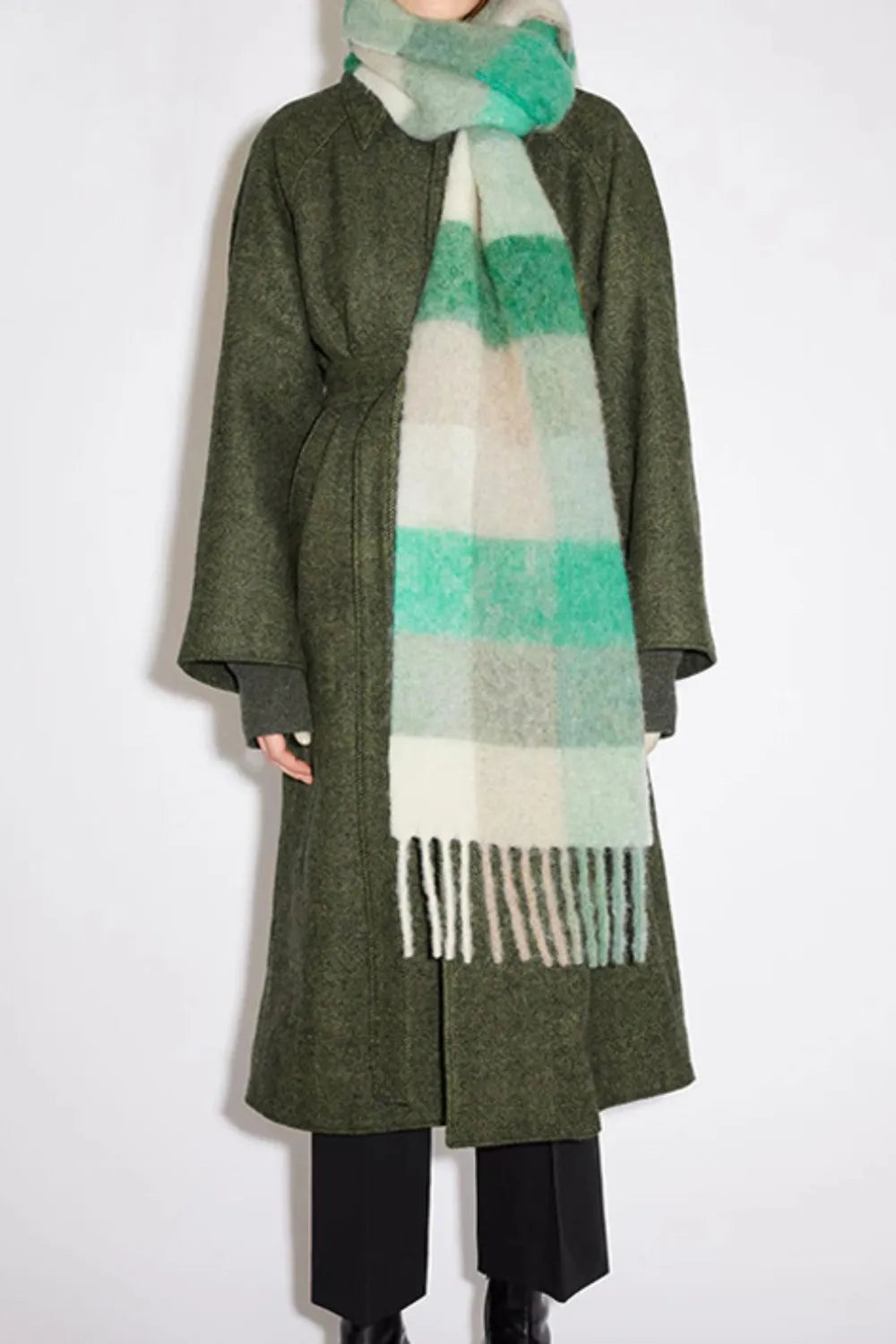 Close up of the plaid pattern and fringe detail