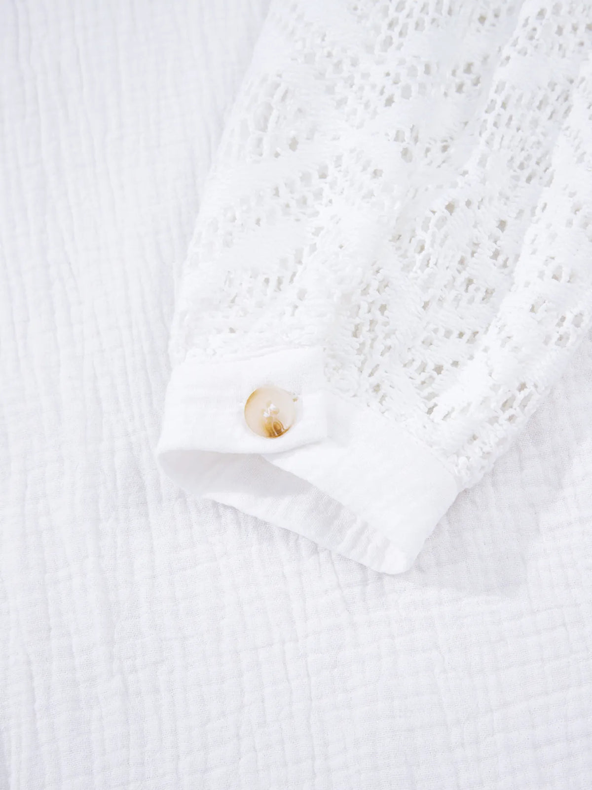 Eyelet sleeve white shirt hem and cuff detail