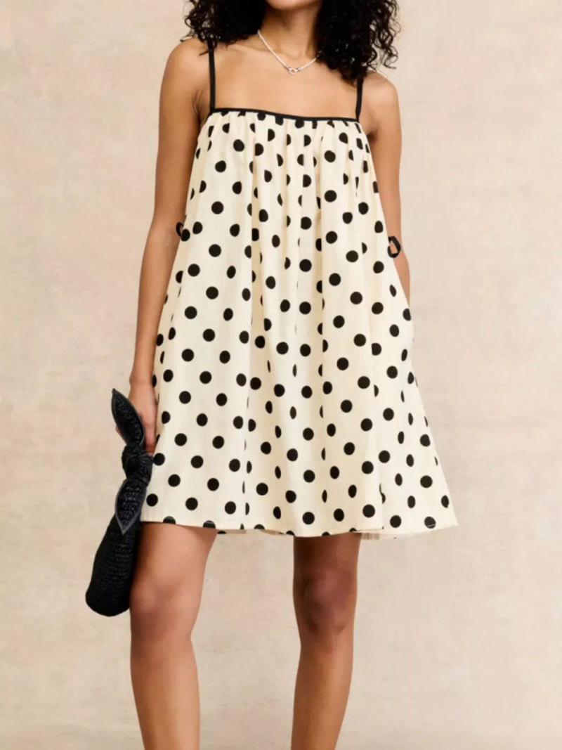 Polka dot spaghetti strap mini dress shown on a model