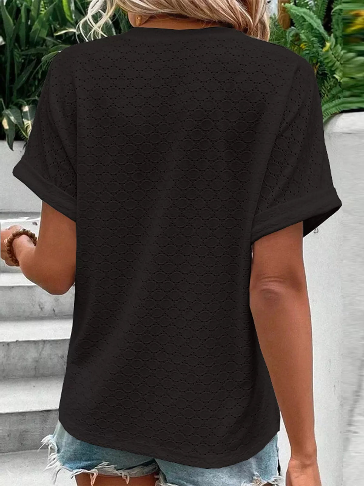Notched neck top styled with jeans and a belt