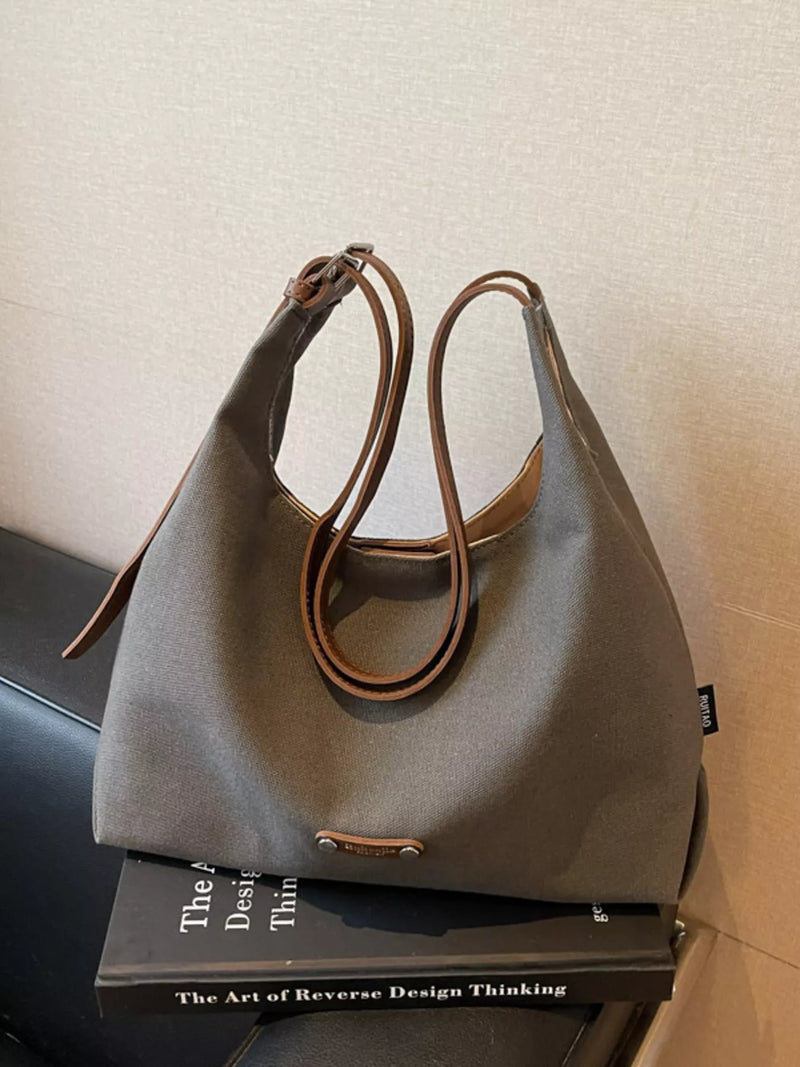 Dark gray canvas shoulder bag with leather straps front view