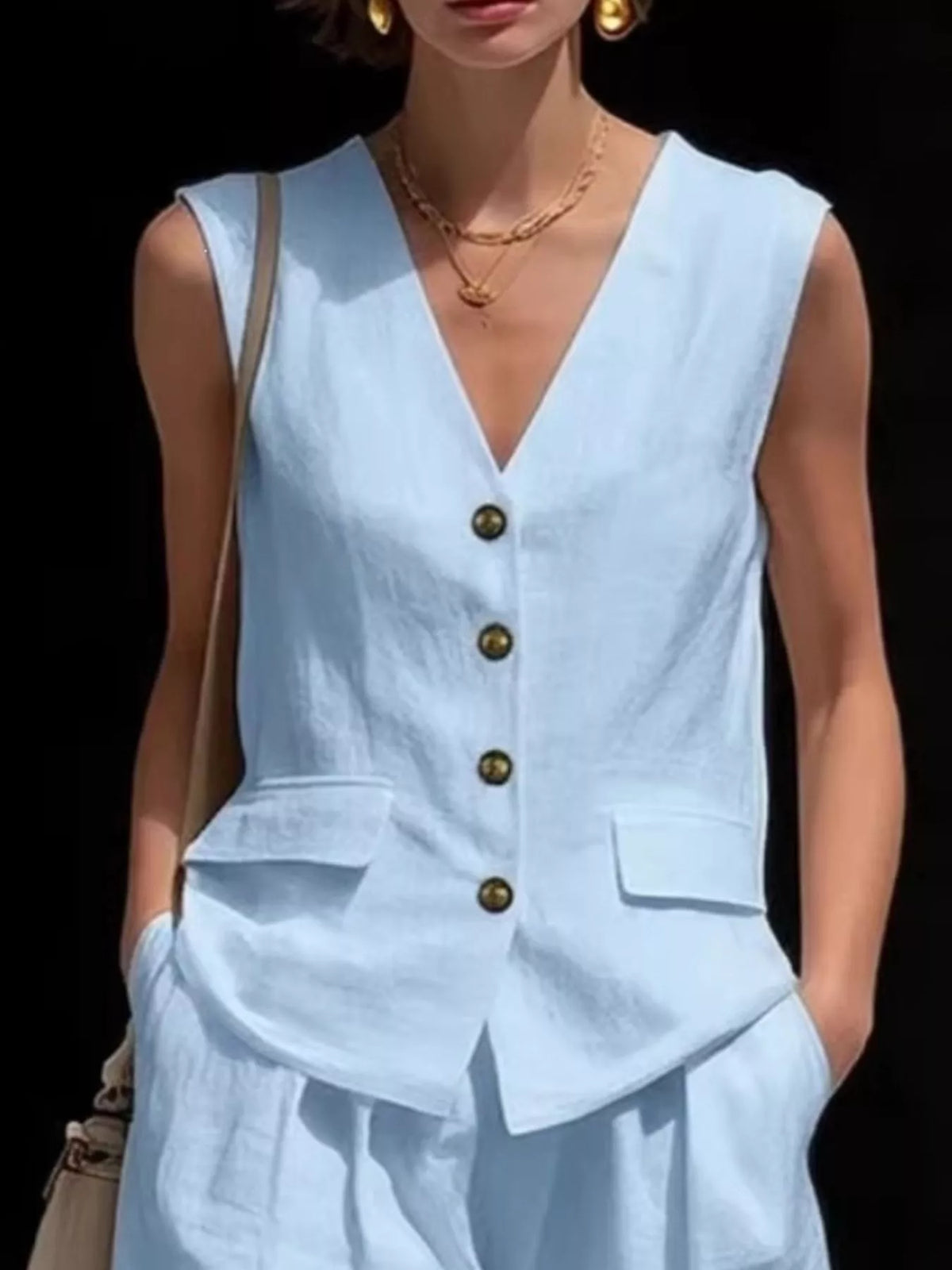 Two piece sleeveless set styled with the vest buttoned
