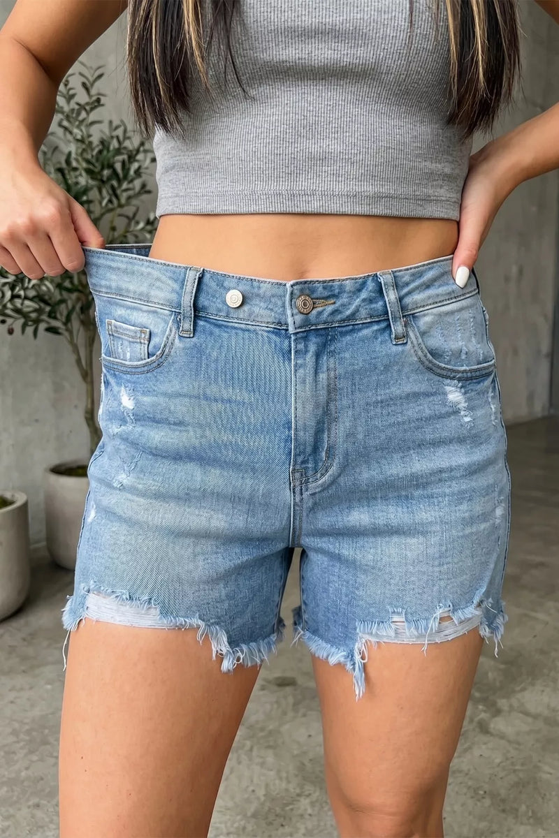 Medium wash distressed raw hem denim shorts front view