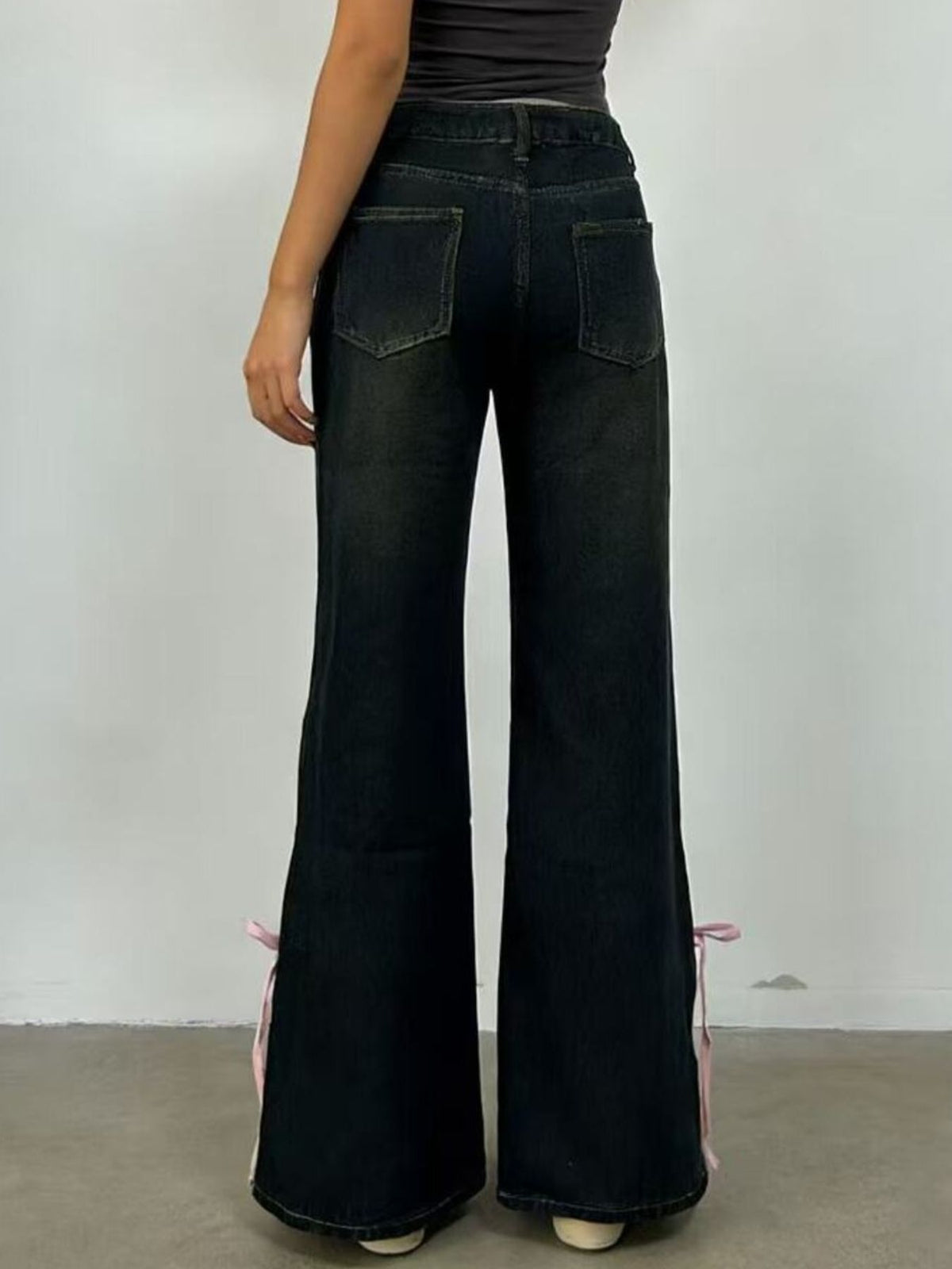 Model wearing ribbon detail flare jeans