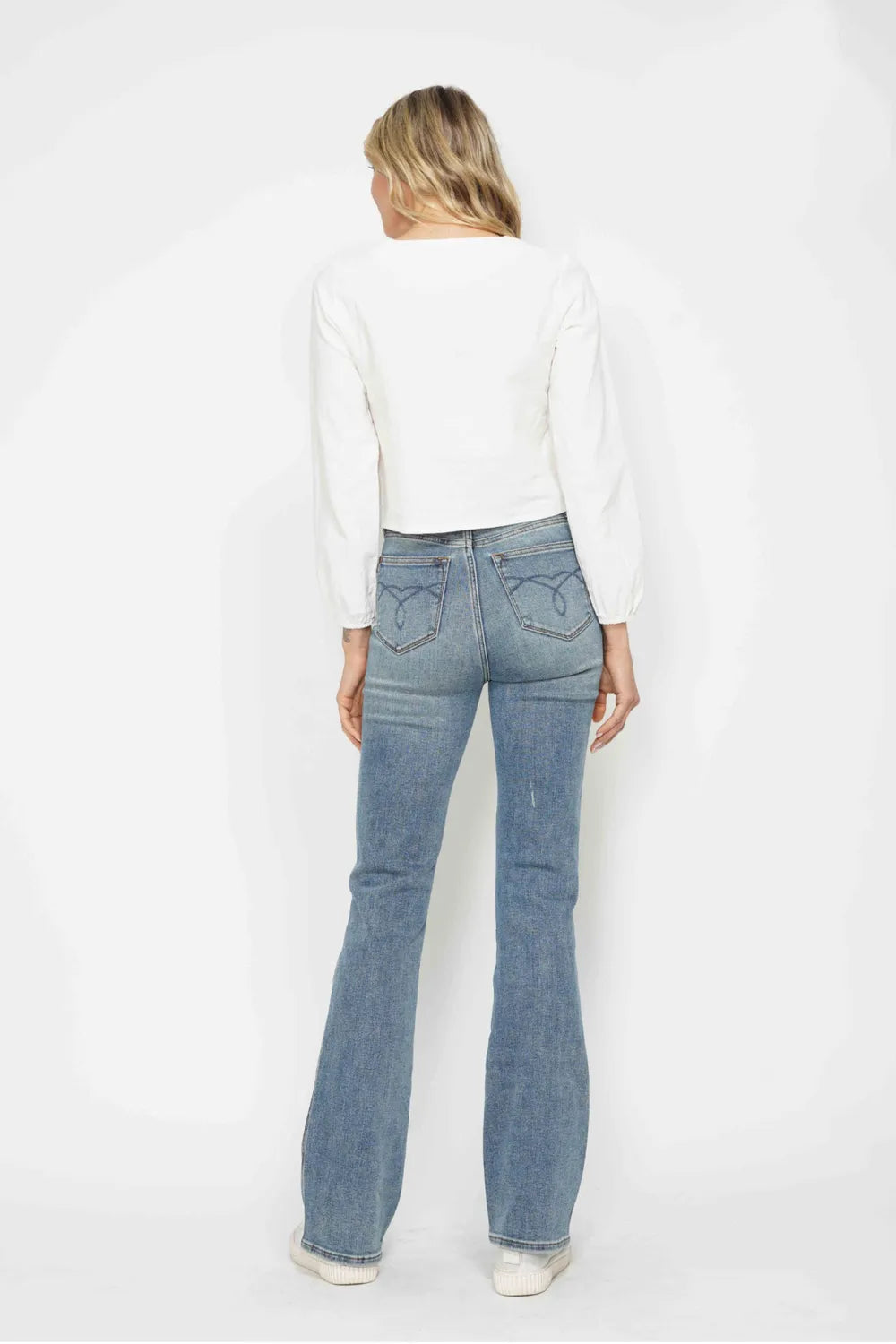 Bootcut leg opening and hem detail on the denim