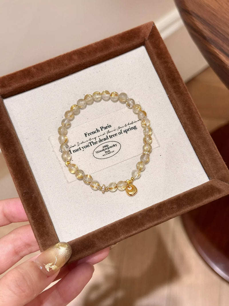 Gold beaded charm bracelet with crystal charm