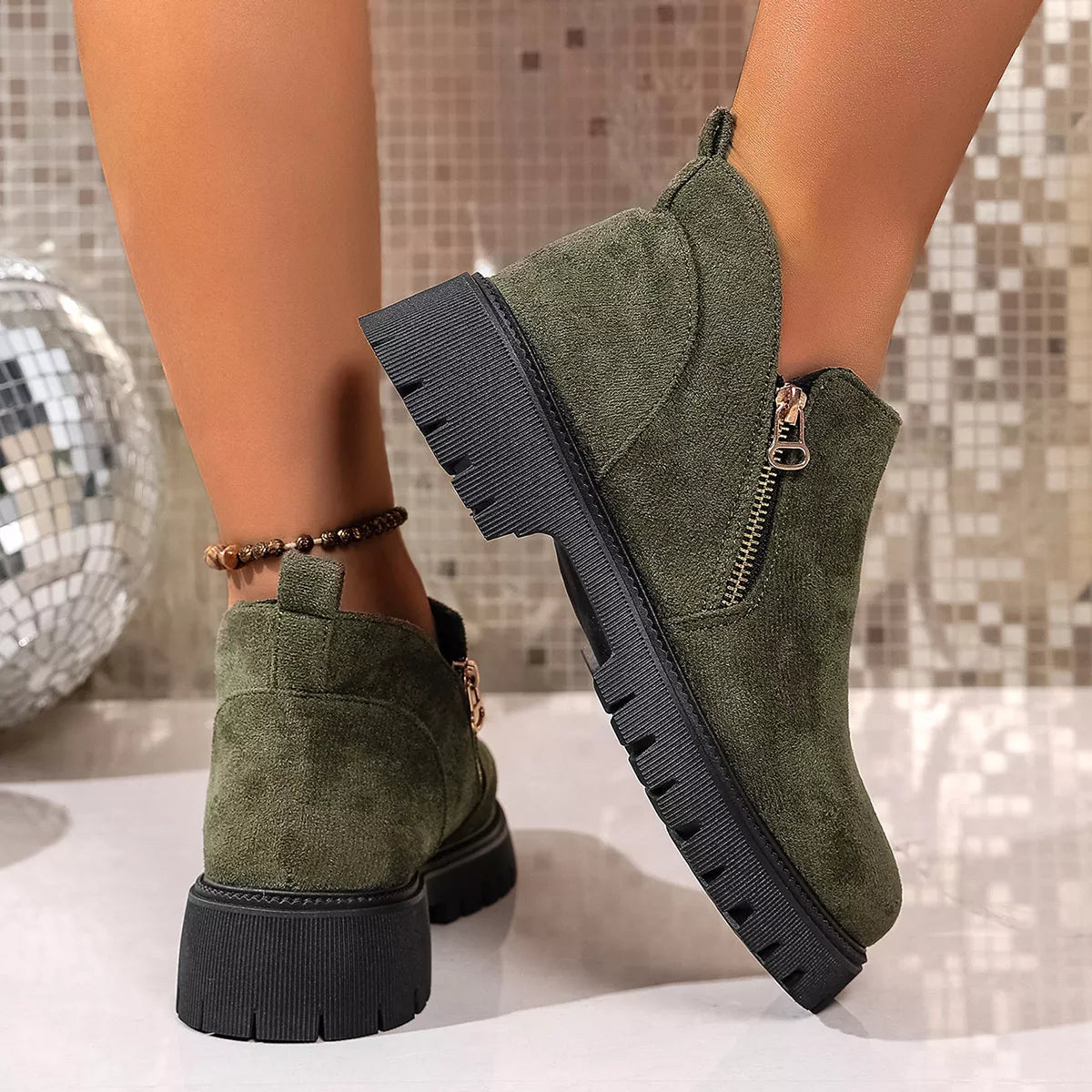 Round toe side zip ankle boots paired with denim