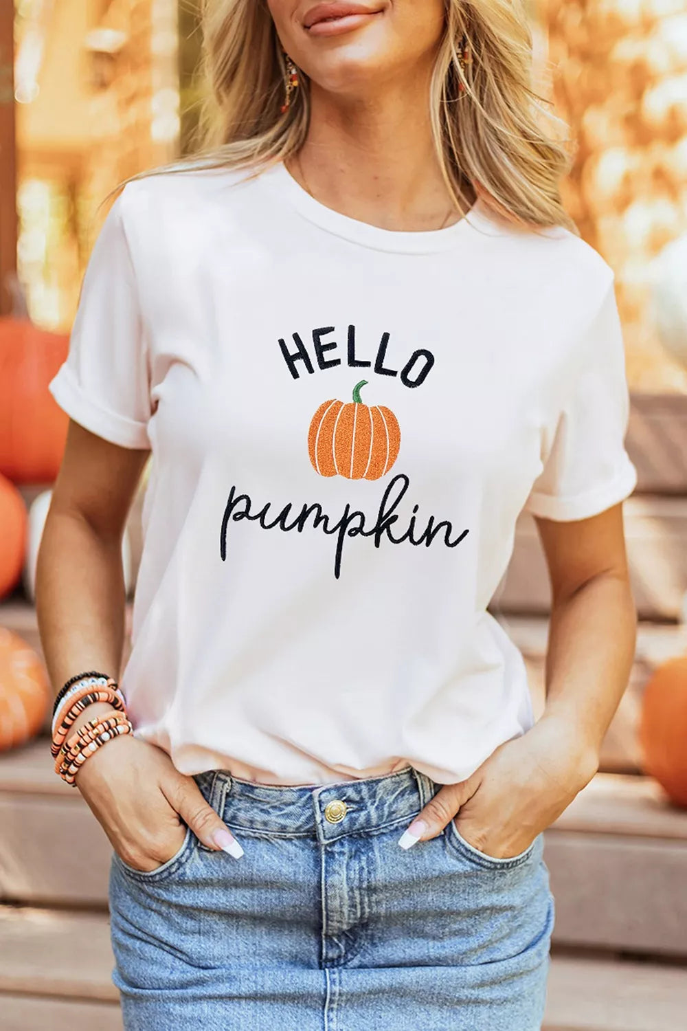 Front view of the white tee showing the embroidered pumpkin slogan