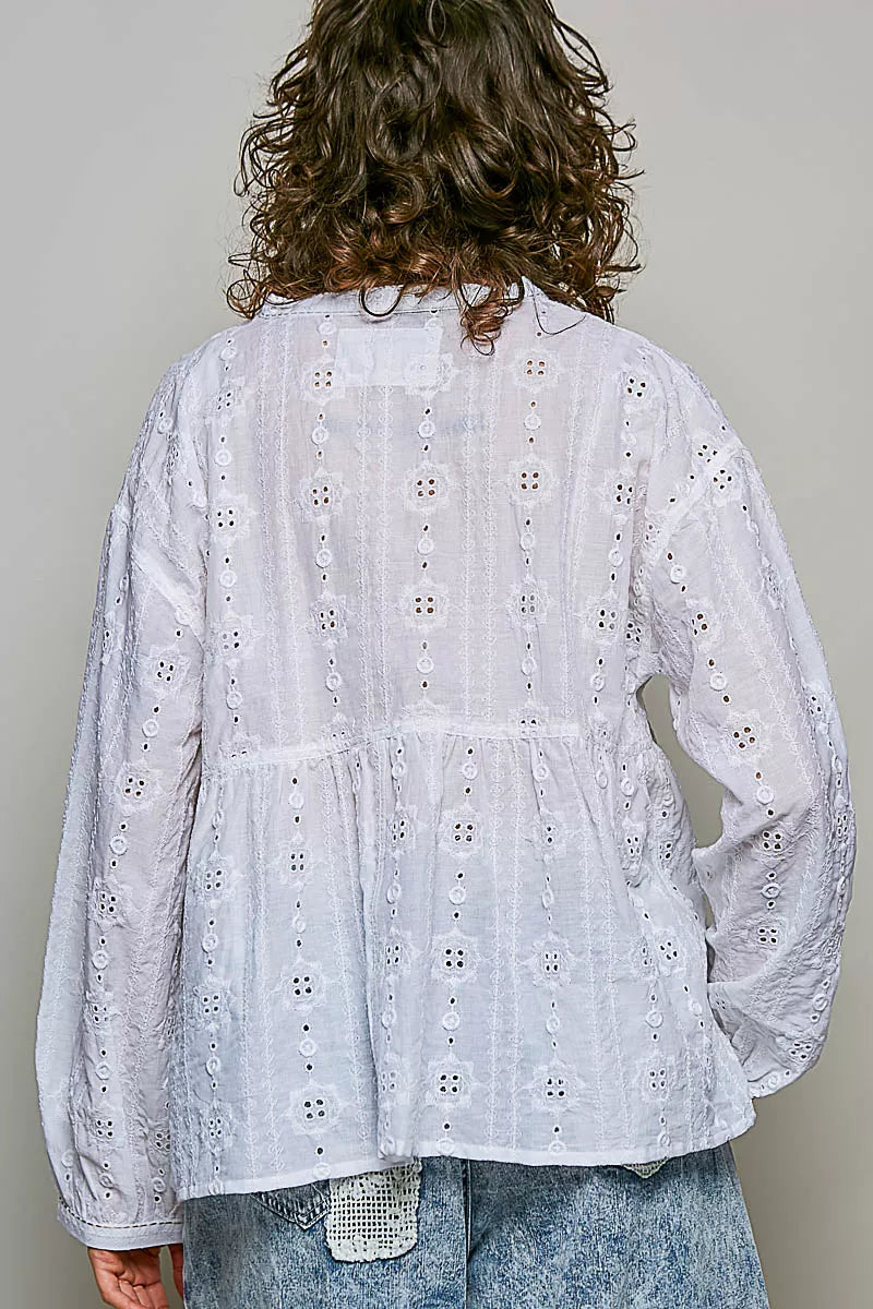 Split neckline with ladder trim on the off white blouse