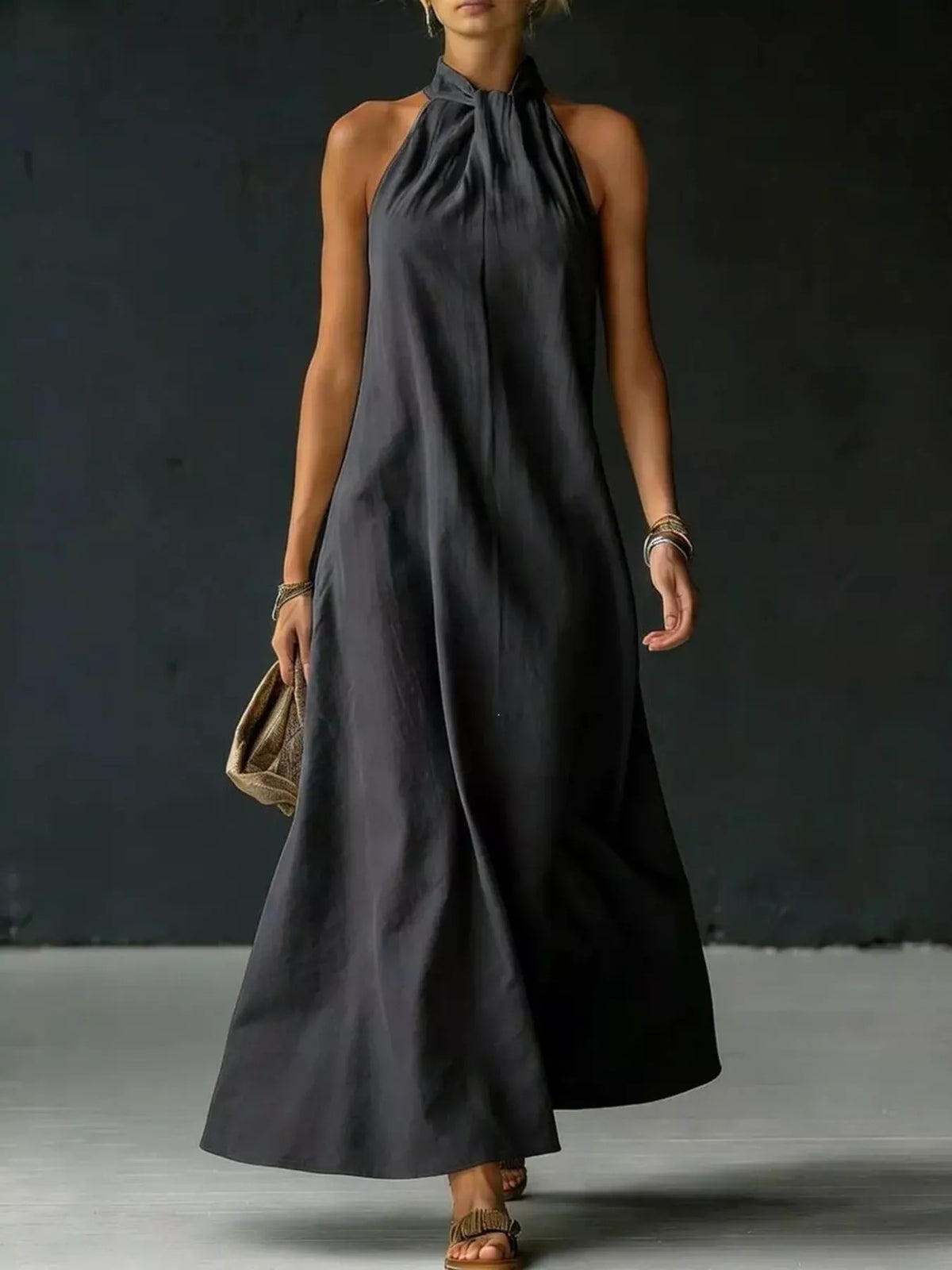 Model wearing halter maxi dress with sandals