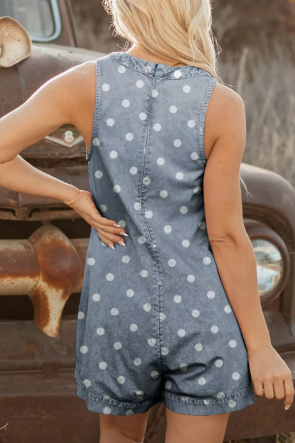 Light blue polka dot denim romper, side view