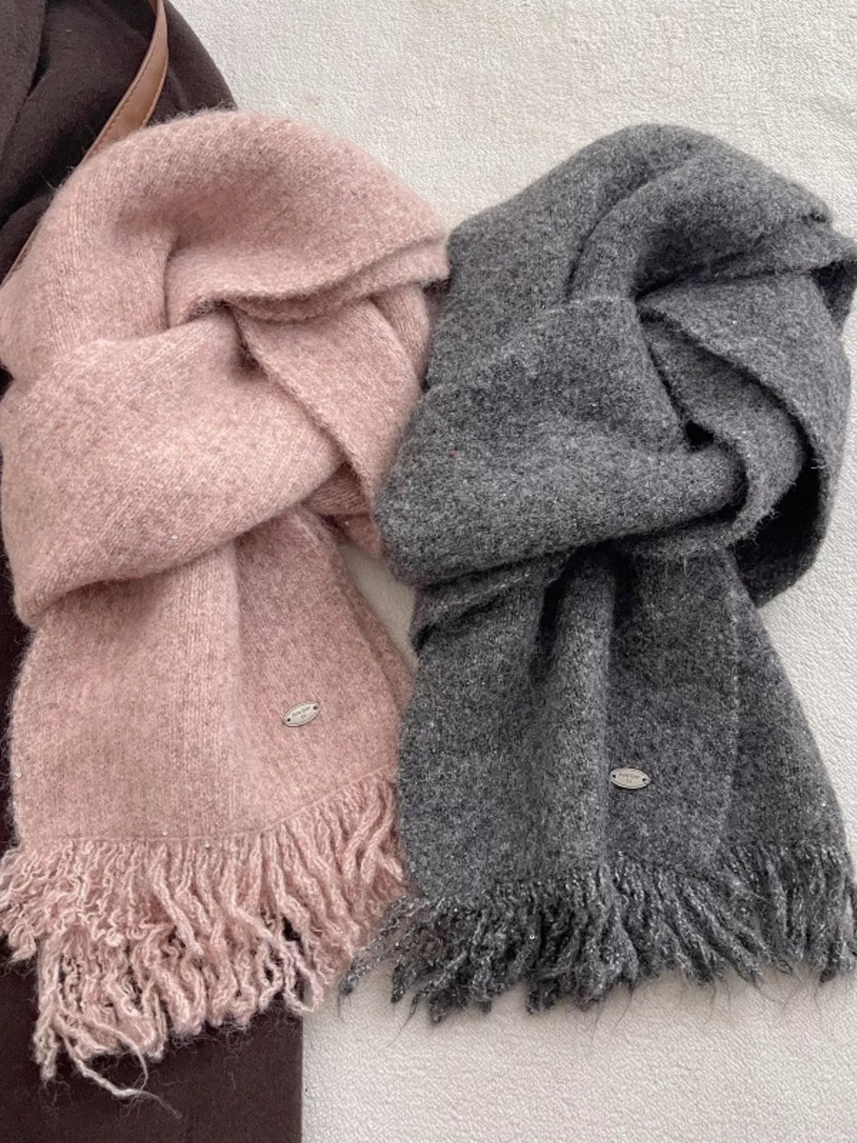 Fringe hem knitted scarf shown in a soft tone