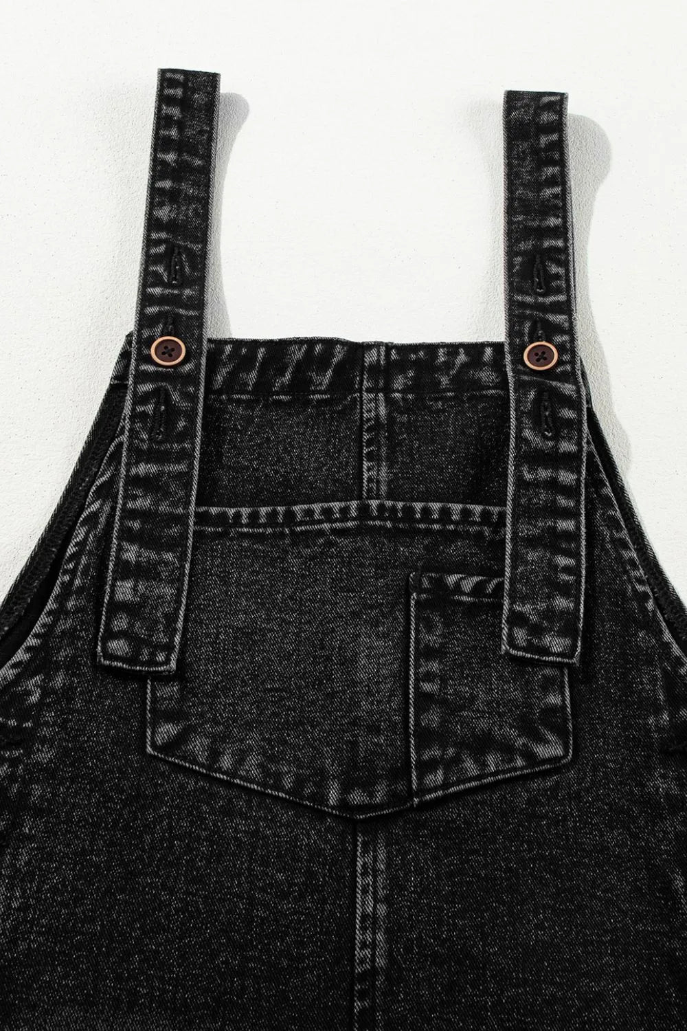 Black overalls adjustable strap detail