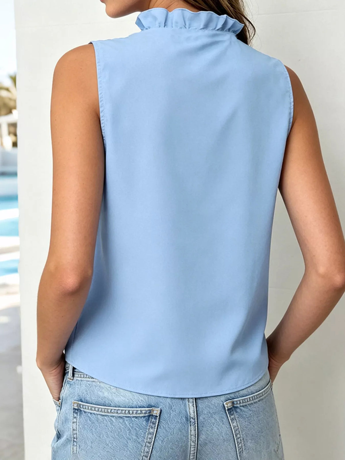 Ruffle blouse side view showing the sleeveless shoulder