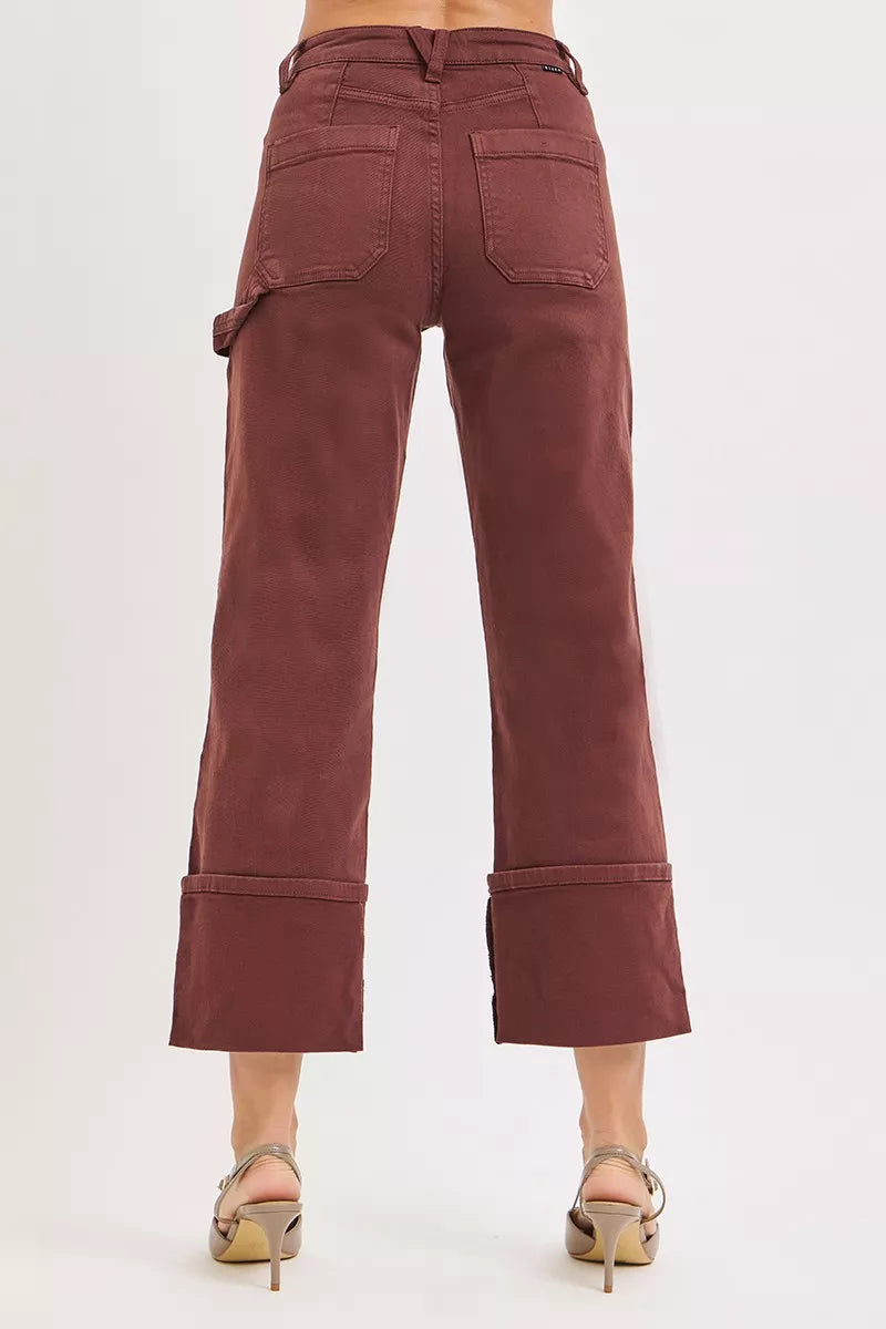 Full outfit styling with cuffed brown jeans