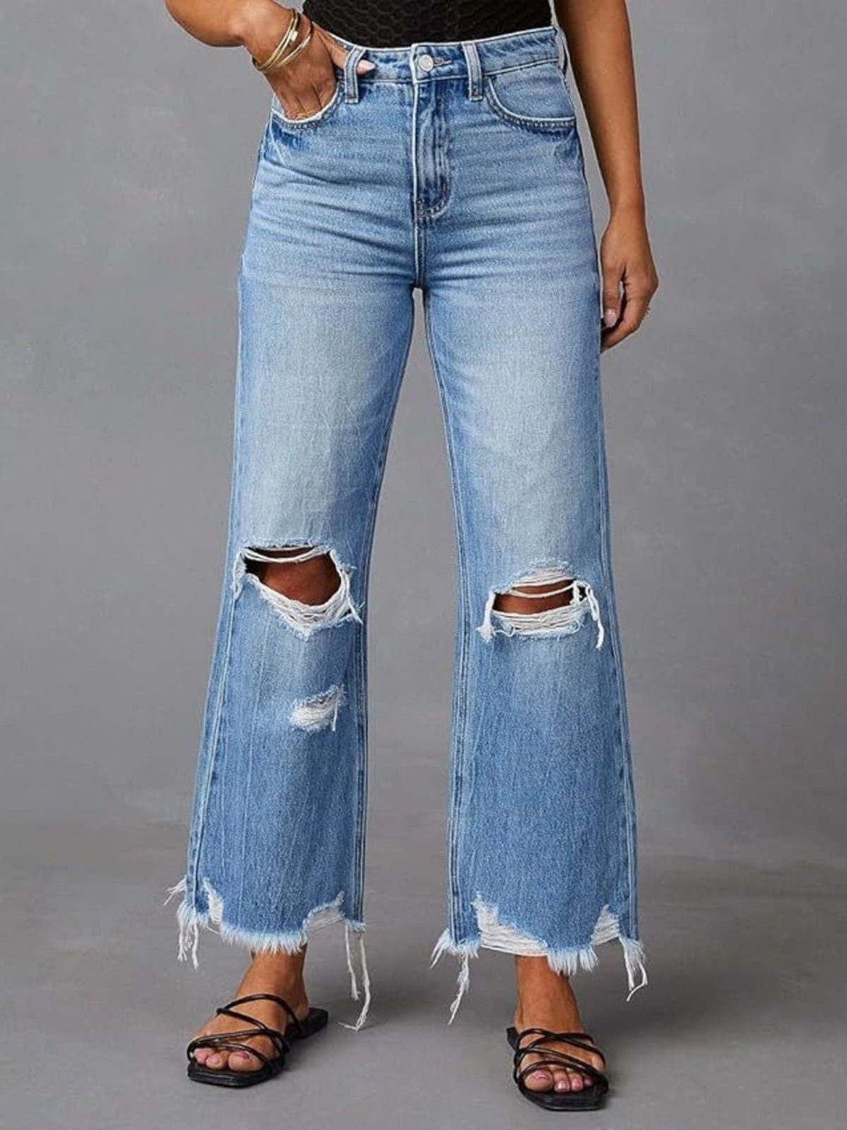 Close up of frayed raw hem on flare jeans