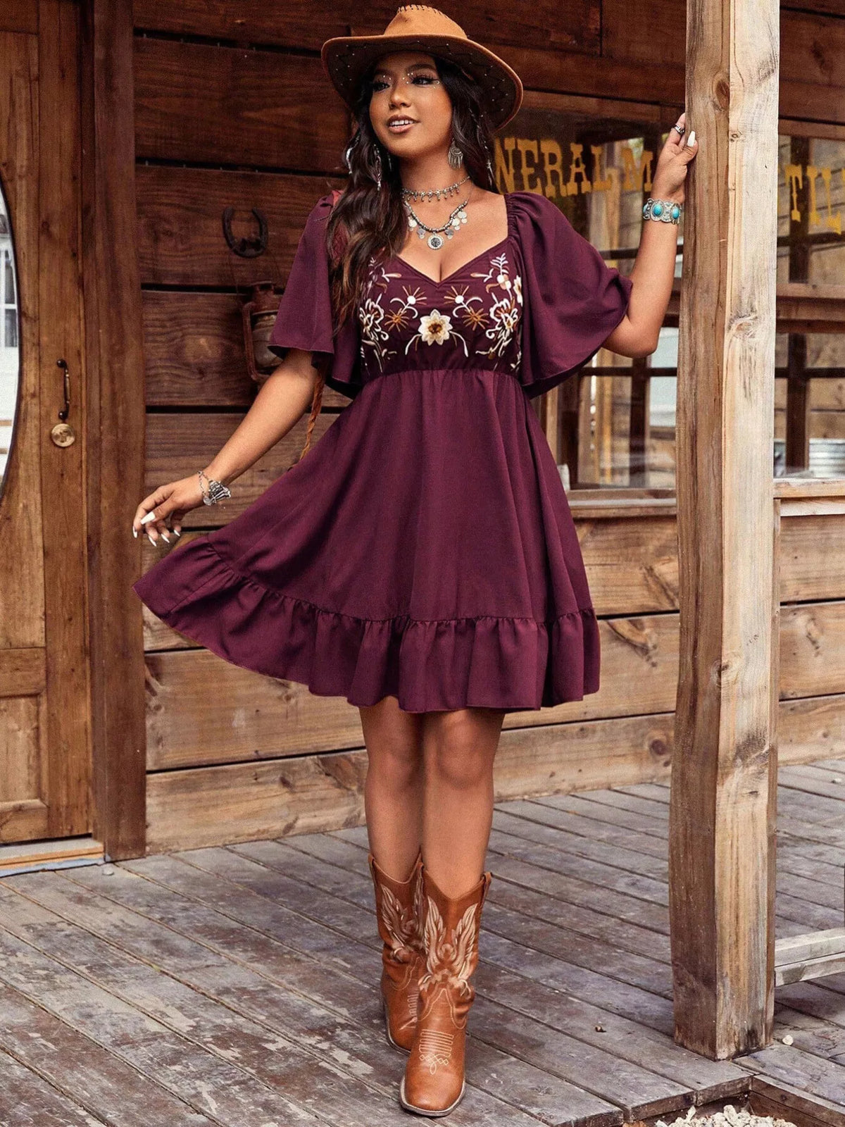 Embroidered mini dress laid flat to show the cut