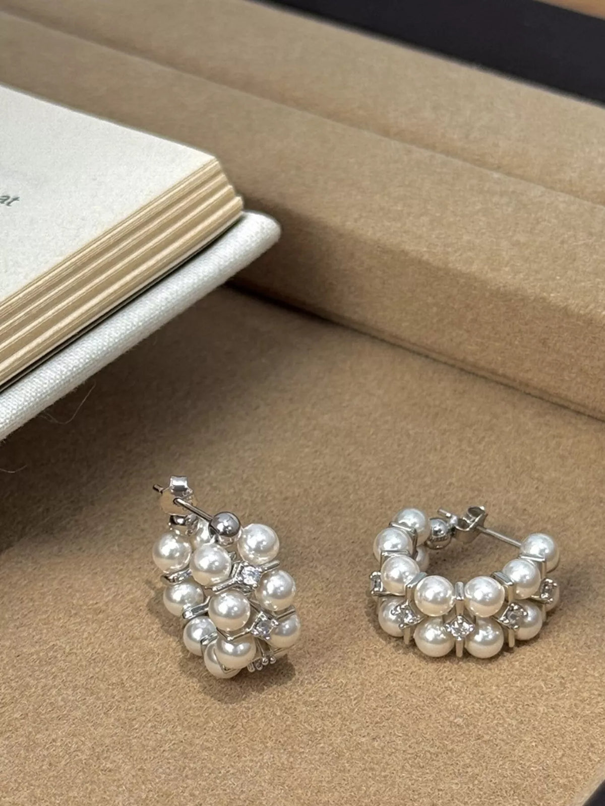 Pearl hoop earrings on ear