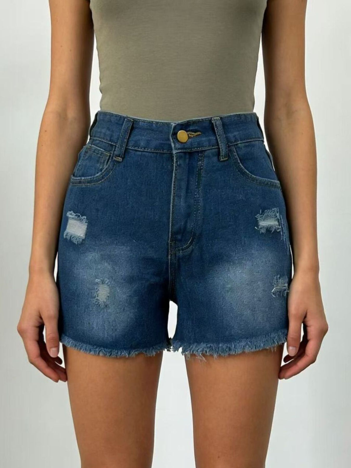 Close up of the raw frayed hem on the jean shorts