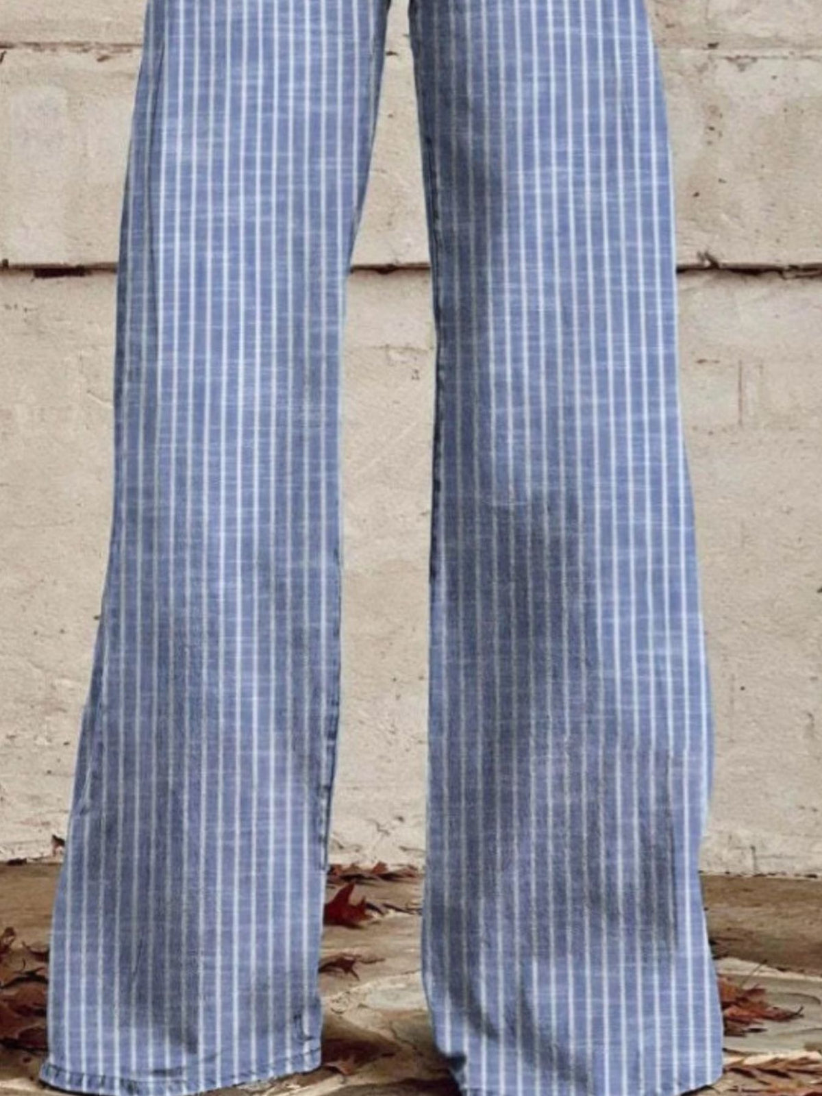 Model wearing striped wide leg jeans