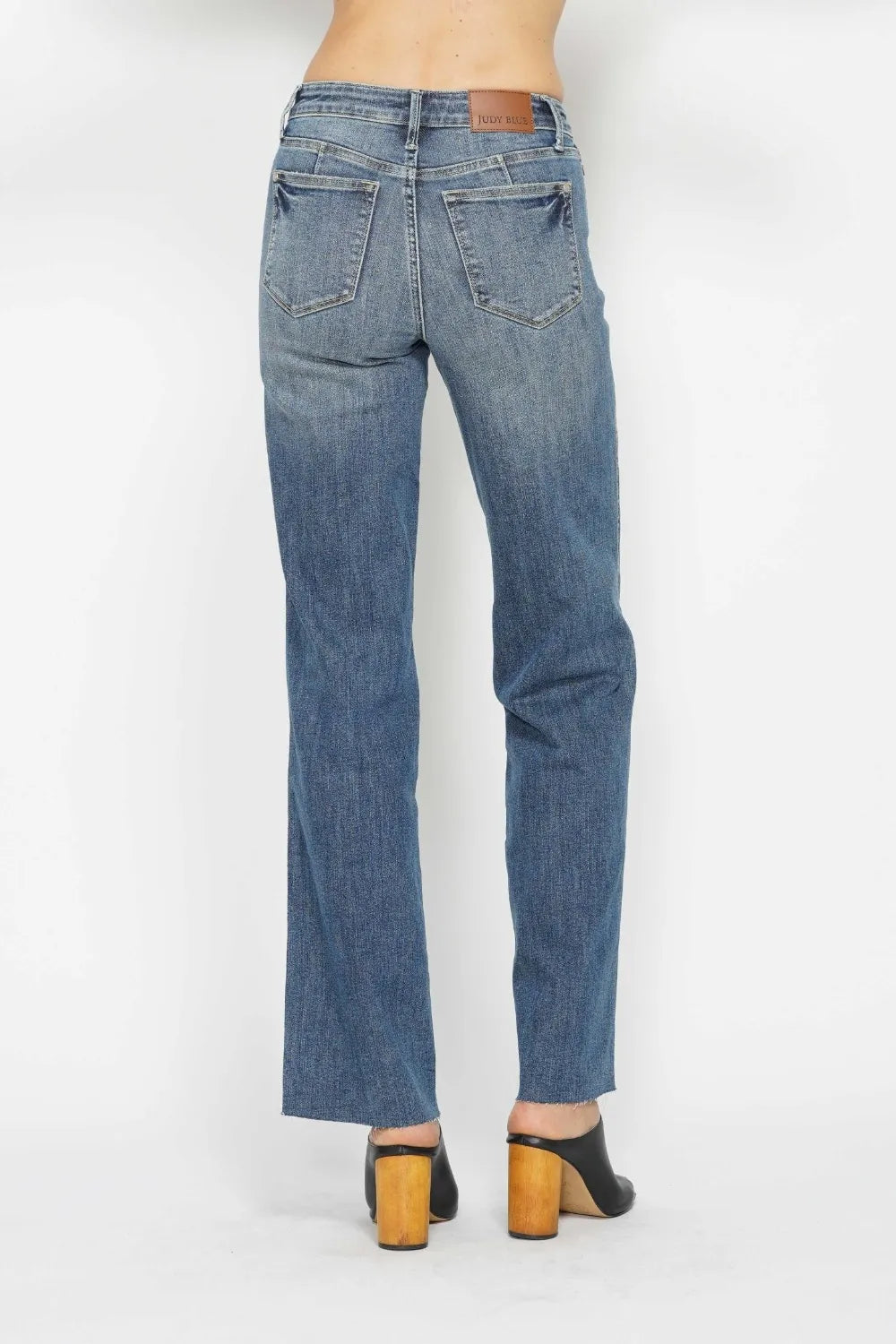 Back view of medium wash straight jeans with pockets