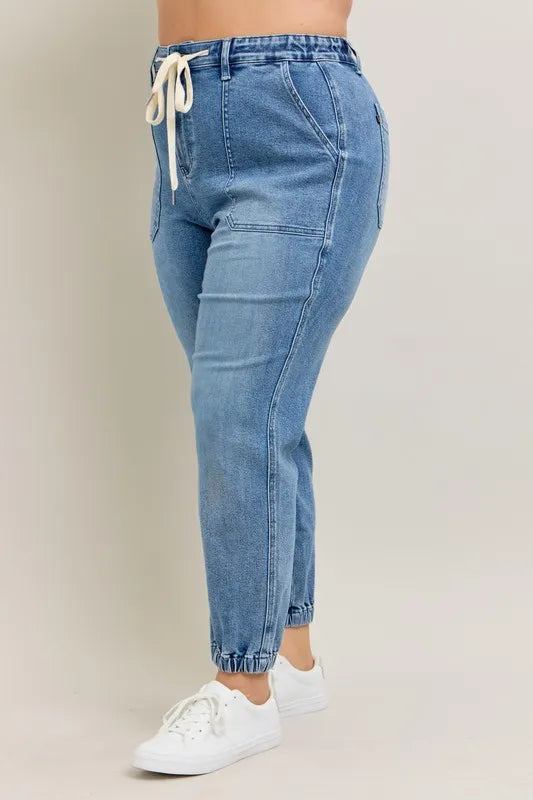 High waist denim joggers seated pose