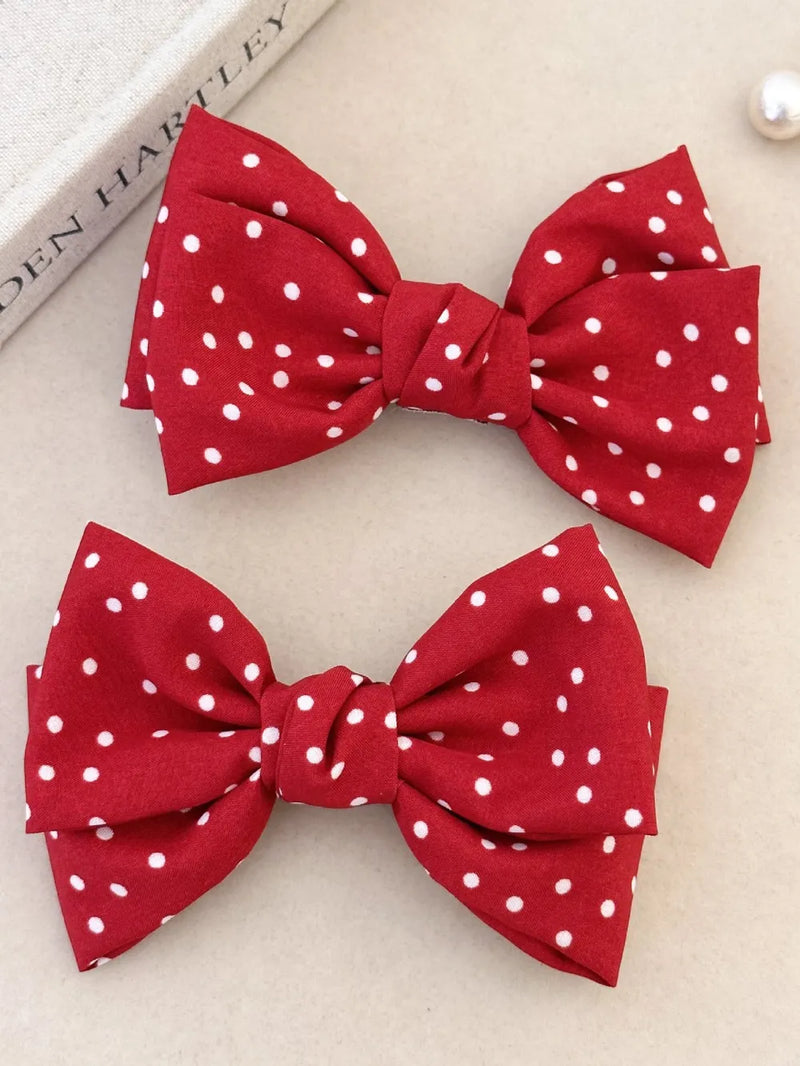Deep red polka dot bow hair clip front view