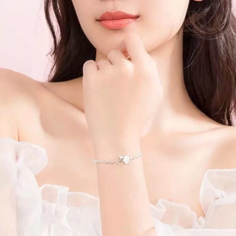 Sterling silver ginkgo leaf bracelet on a plain background