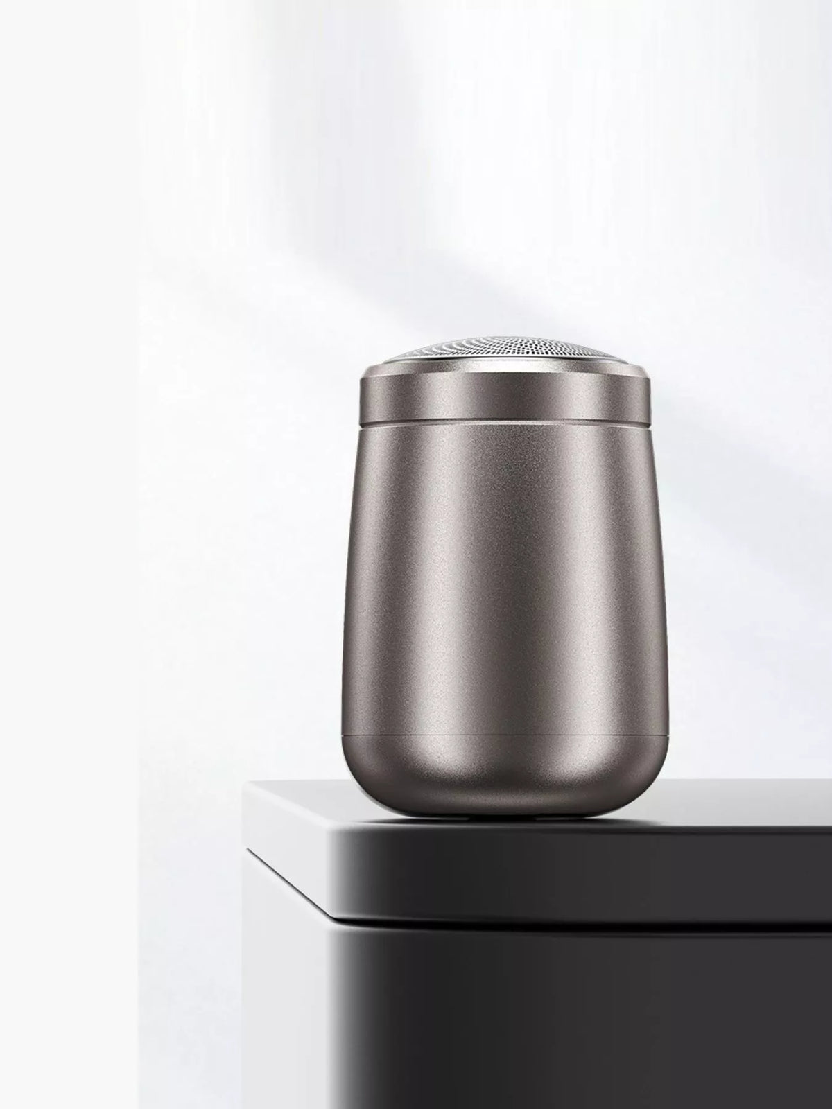 Portable dark gray electric shaver full view