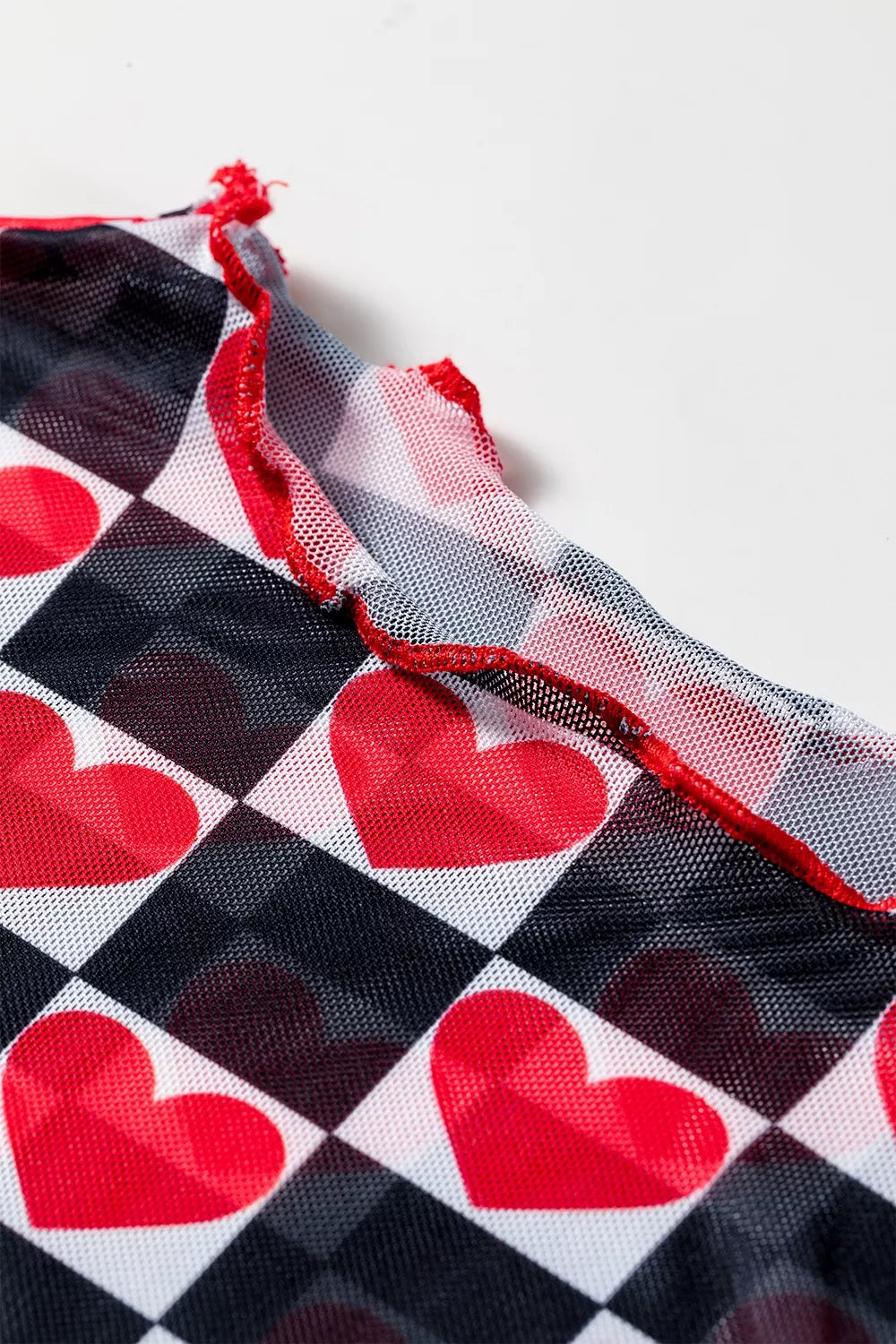 Three quarter view of plaid heart mesh long sleeve top