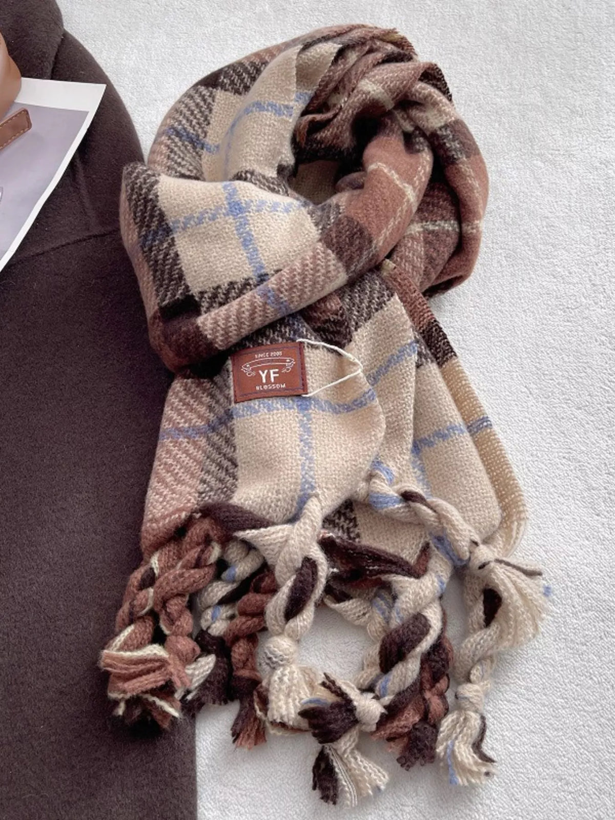 Detail of the soft tassel ends on the plaid scarf