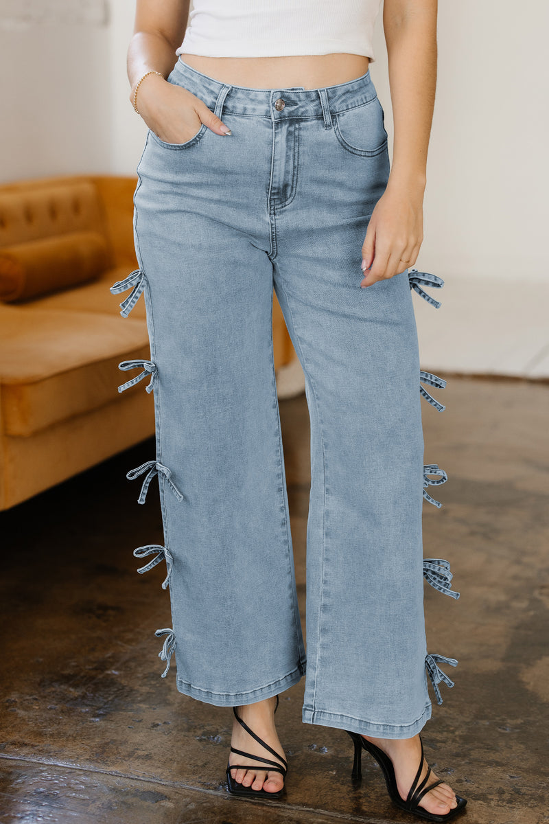 Bow knot straight leg jeans front view in blue denim