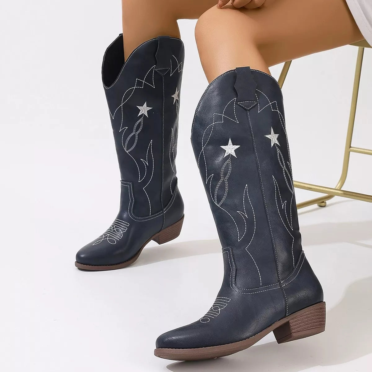 Western star embroidered cowboy boots close up detail