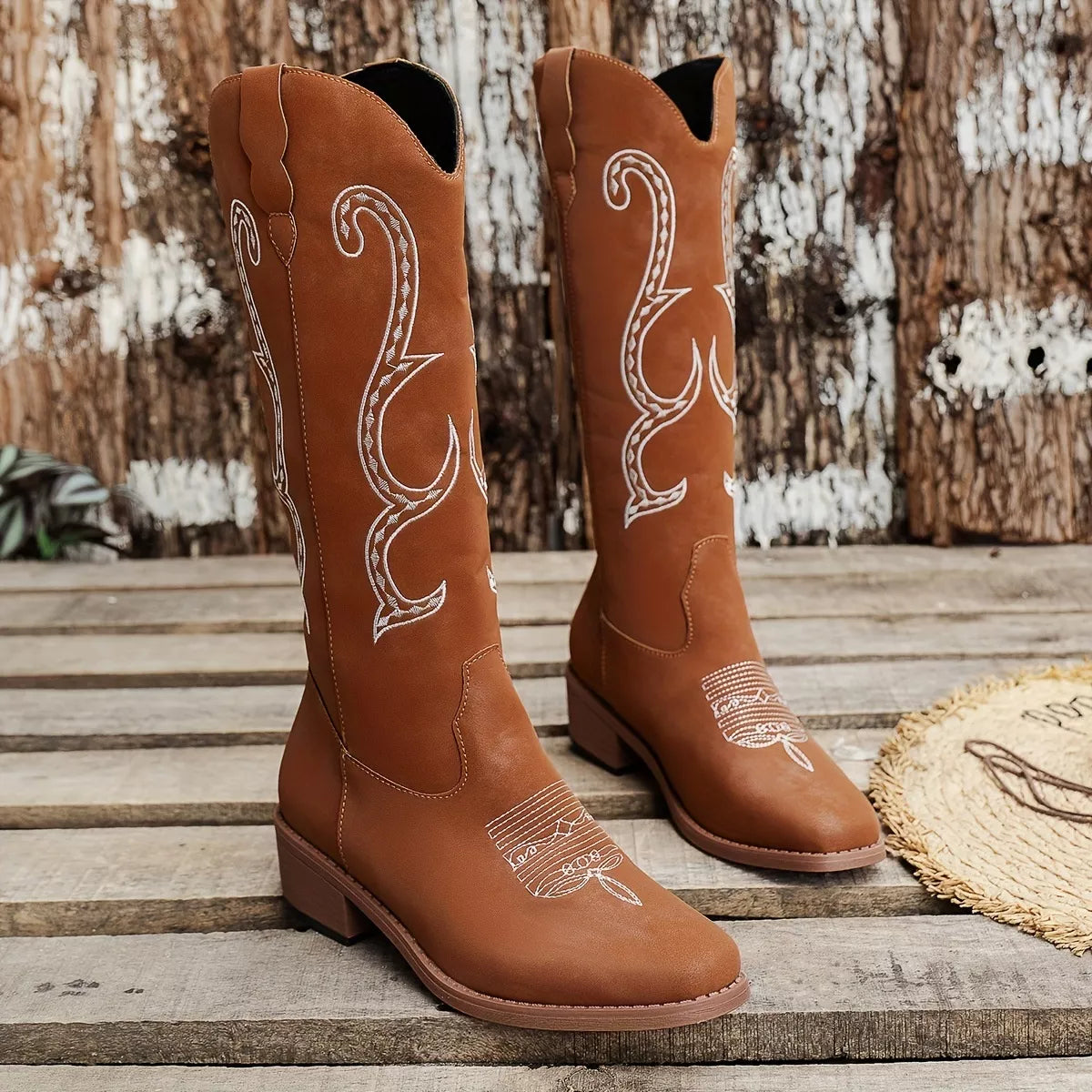 Embroidered round toe block heel boots styled on model