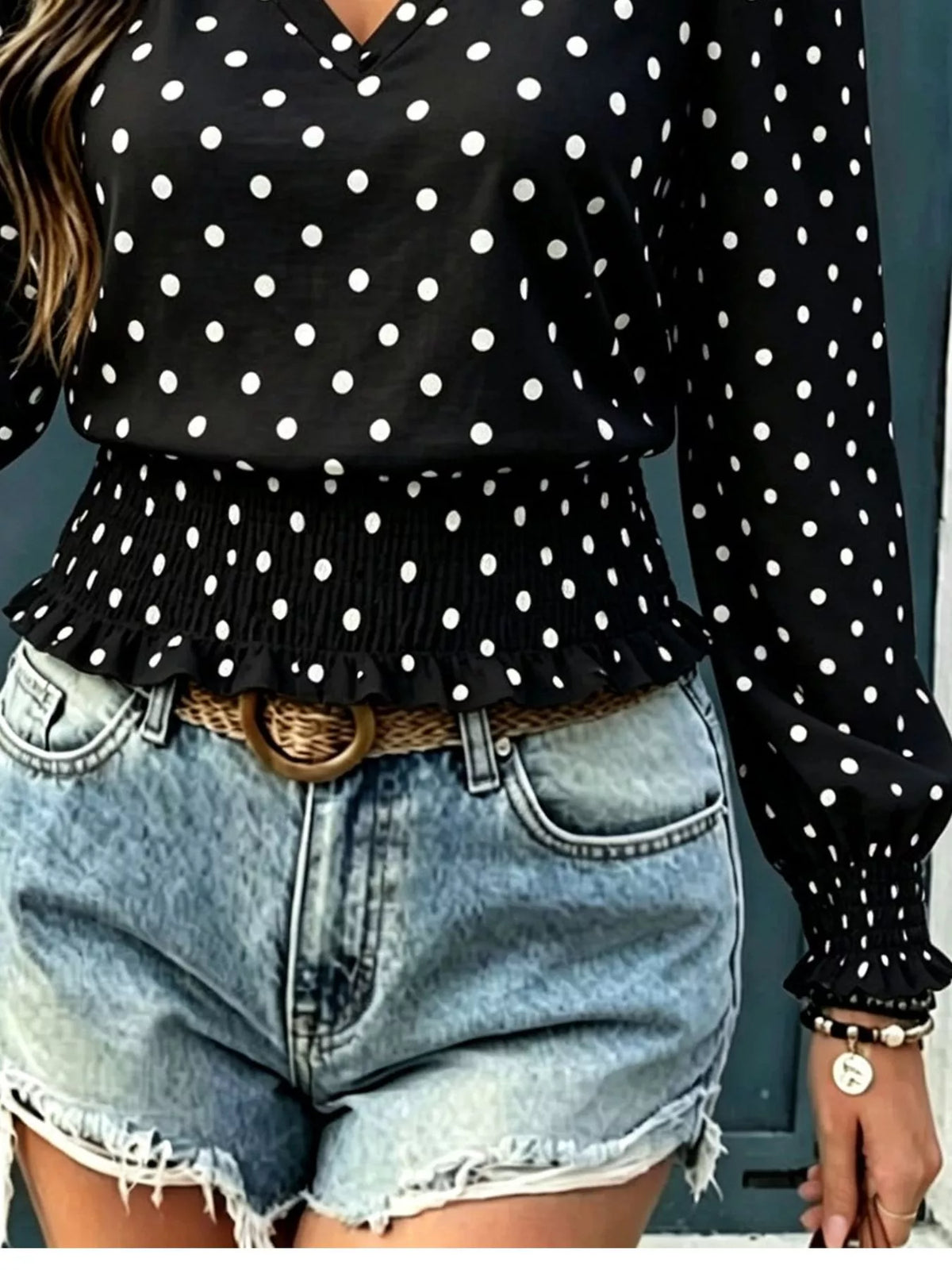 Polka dot blouse styled with trousers