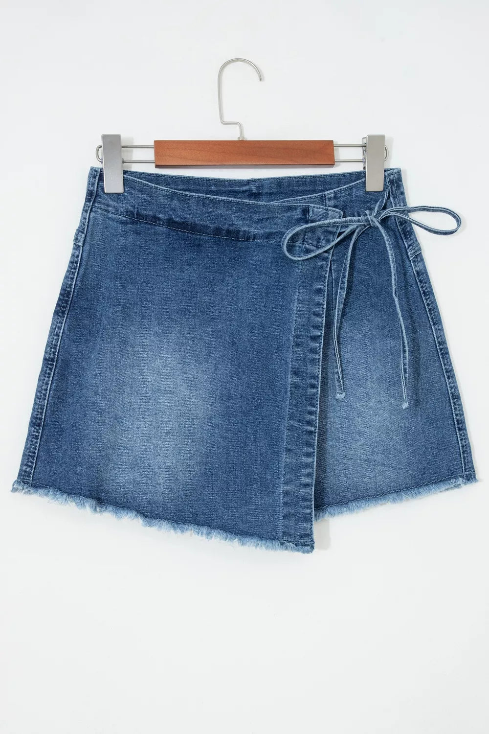 Medium wash wrapped tie waist denim skort styled view