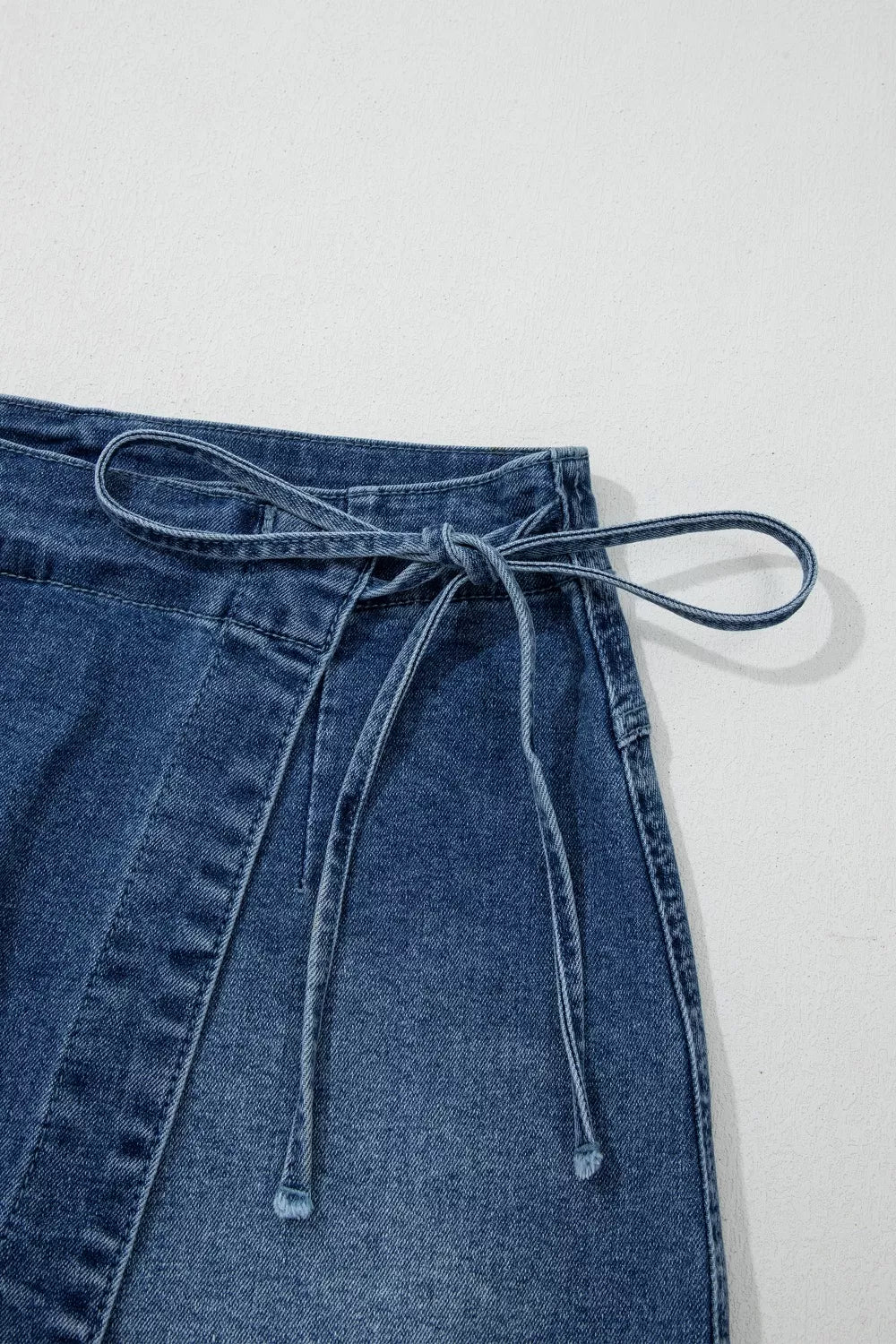 Medium wash wrapped tie waist denim skort back view