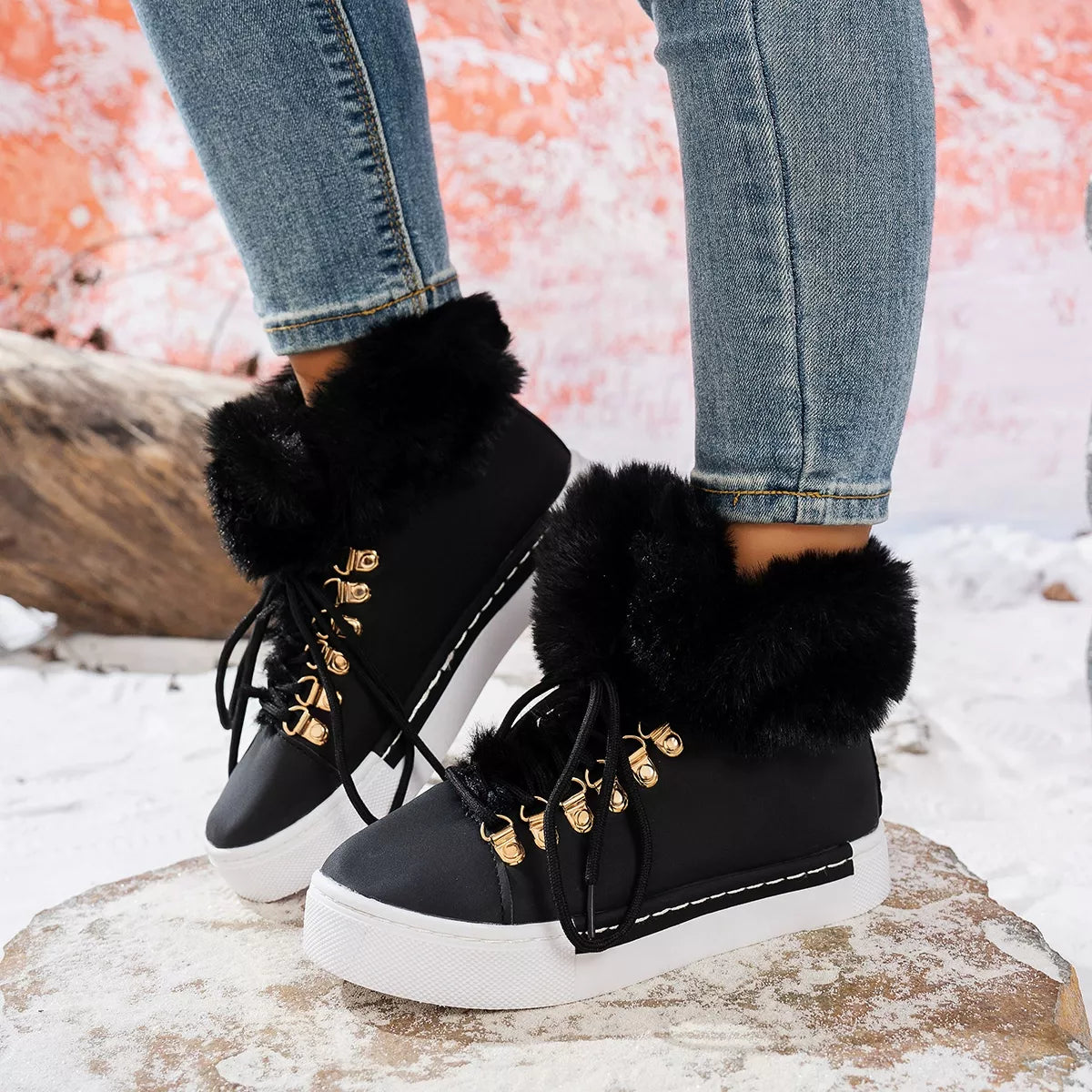 Fuzzy trim lace up ankle boots pair styled together