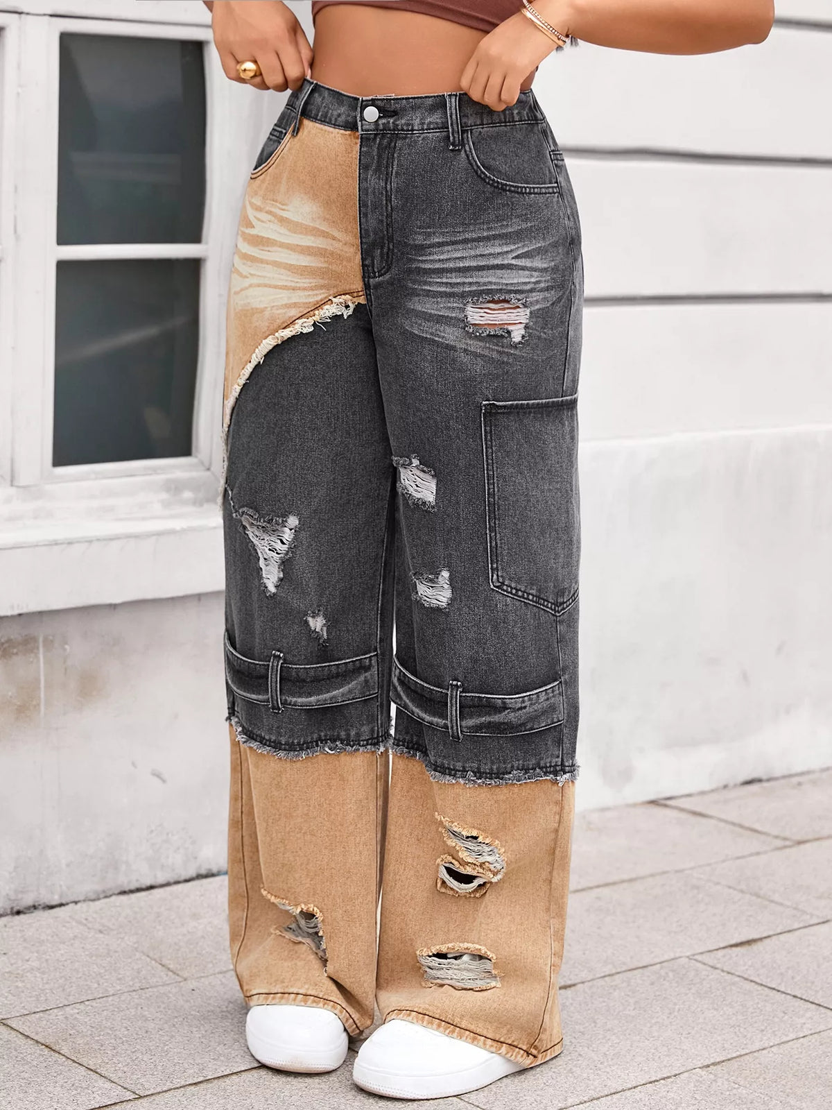 Model wearing two tone ripped wide leg jeans