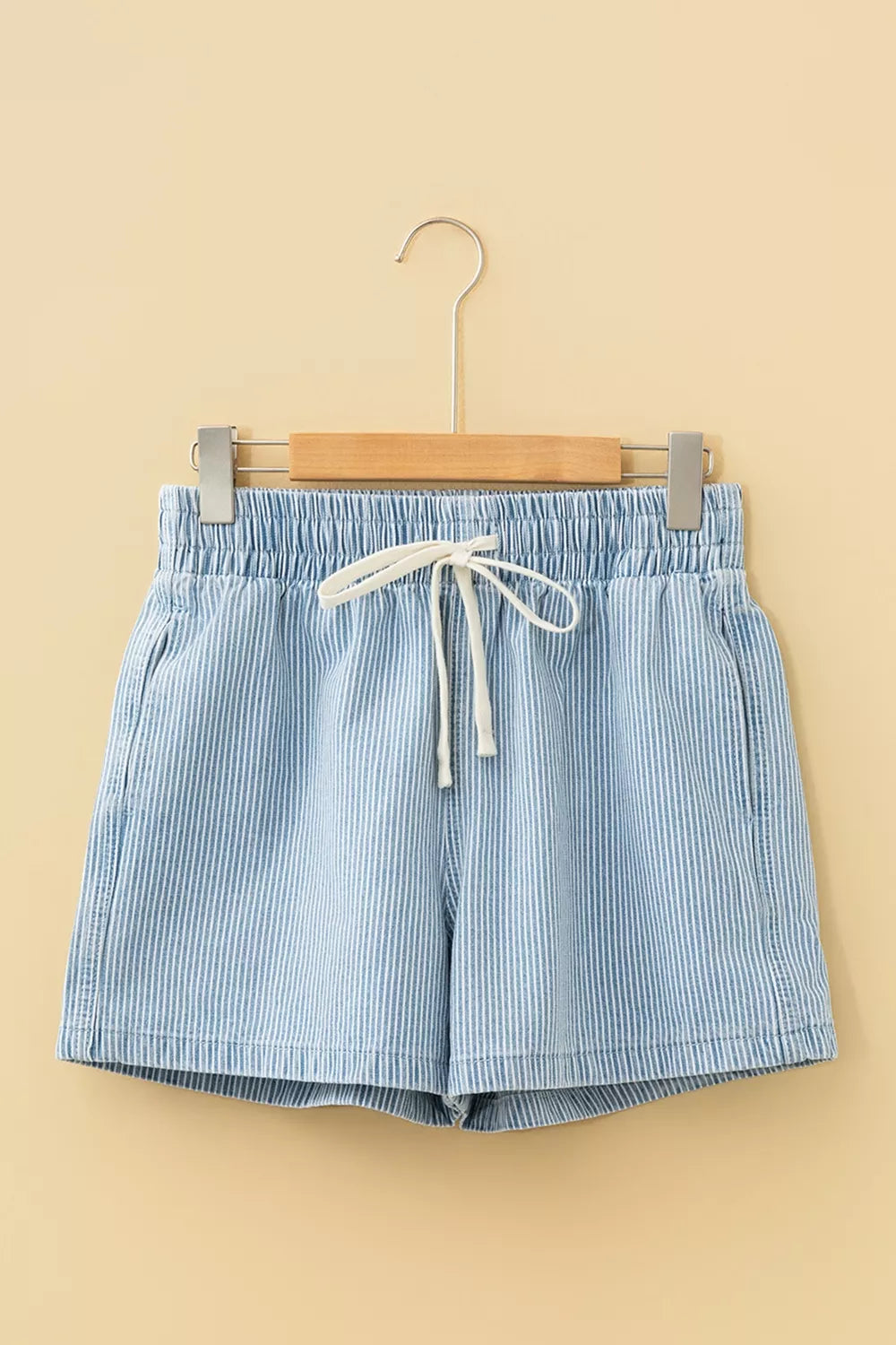 Light blue striped drawstring shorts close up view