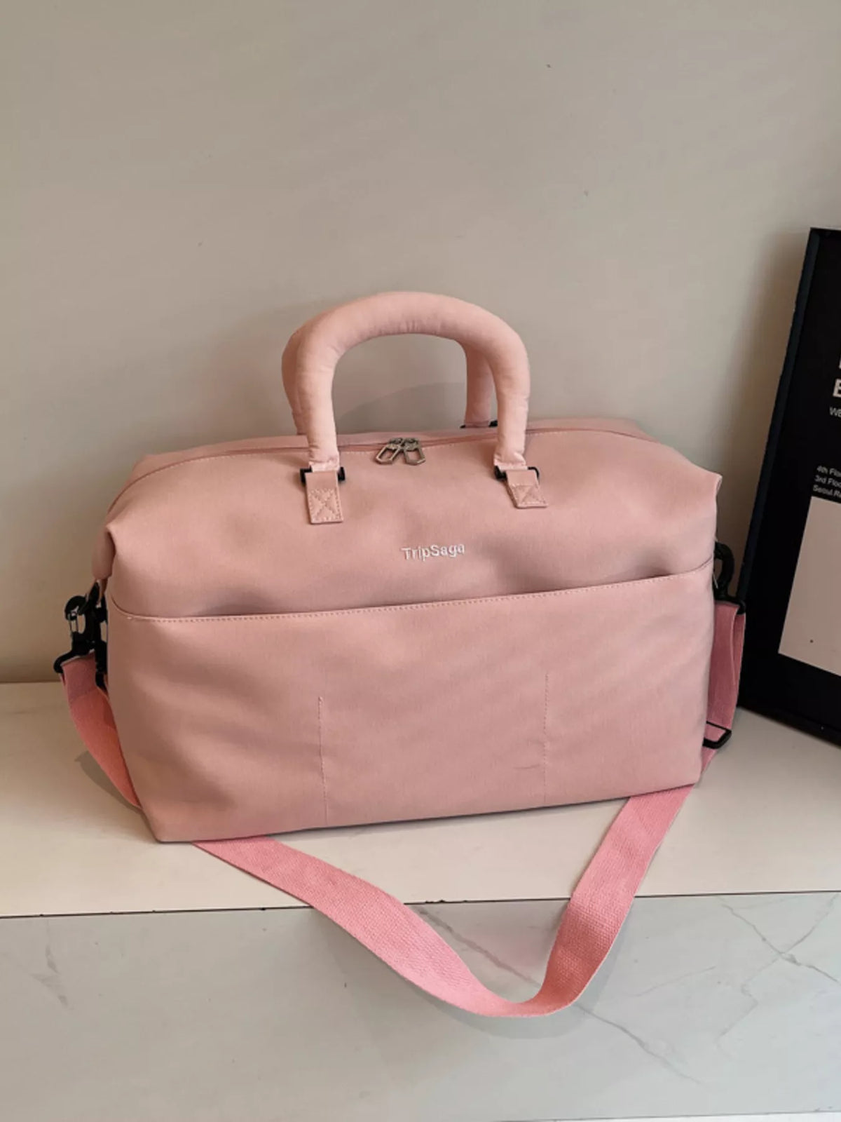 Pink duffel bag with padded handles side view