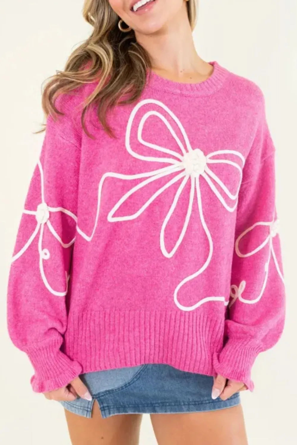 Fuchsia pink bow print dropped shoulder sweater front view