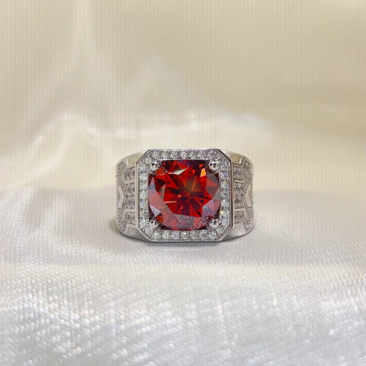 5 carat red moissanite halo ring in sterling silver on a soft fabric background