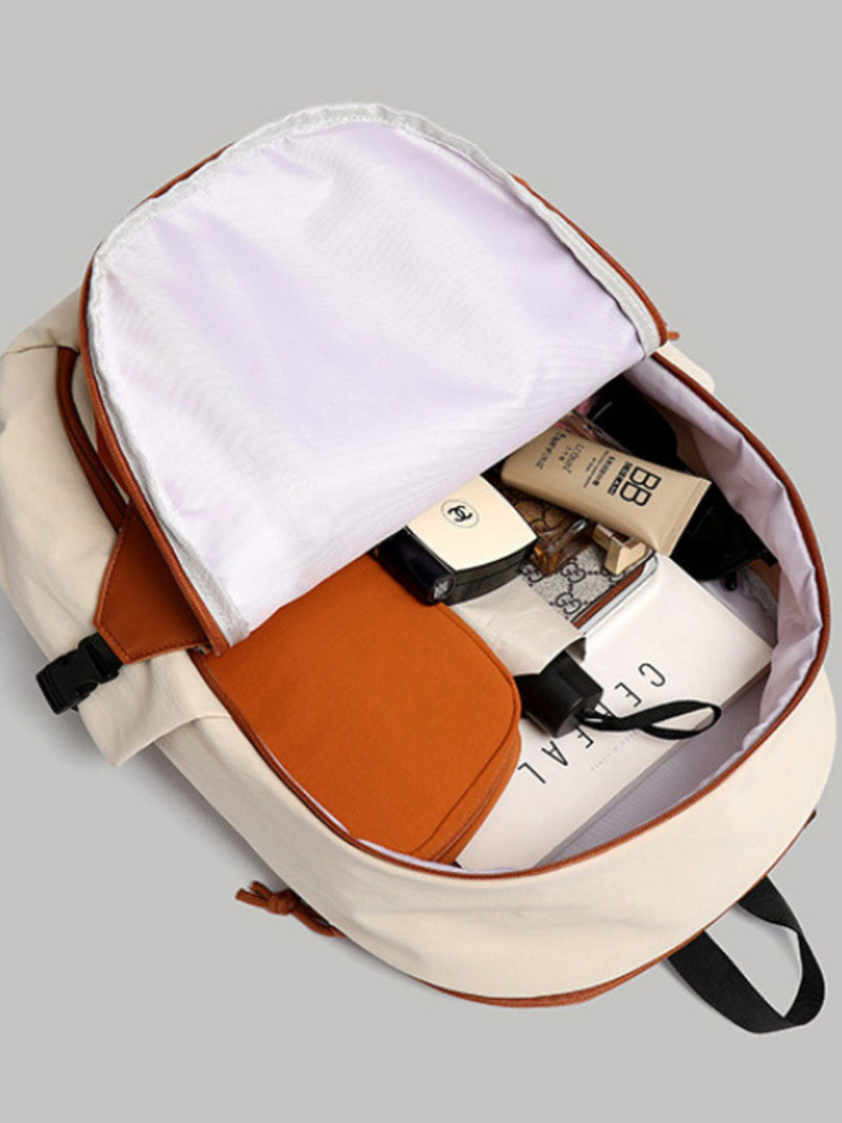 Orange color block nylon backpack flat lay styling