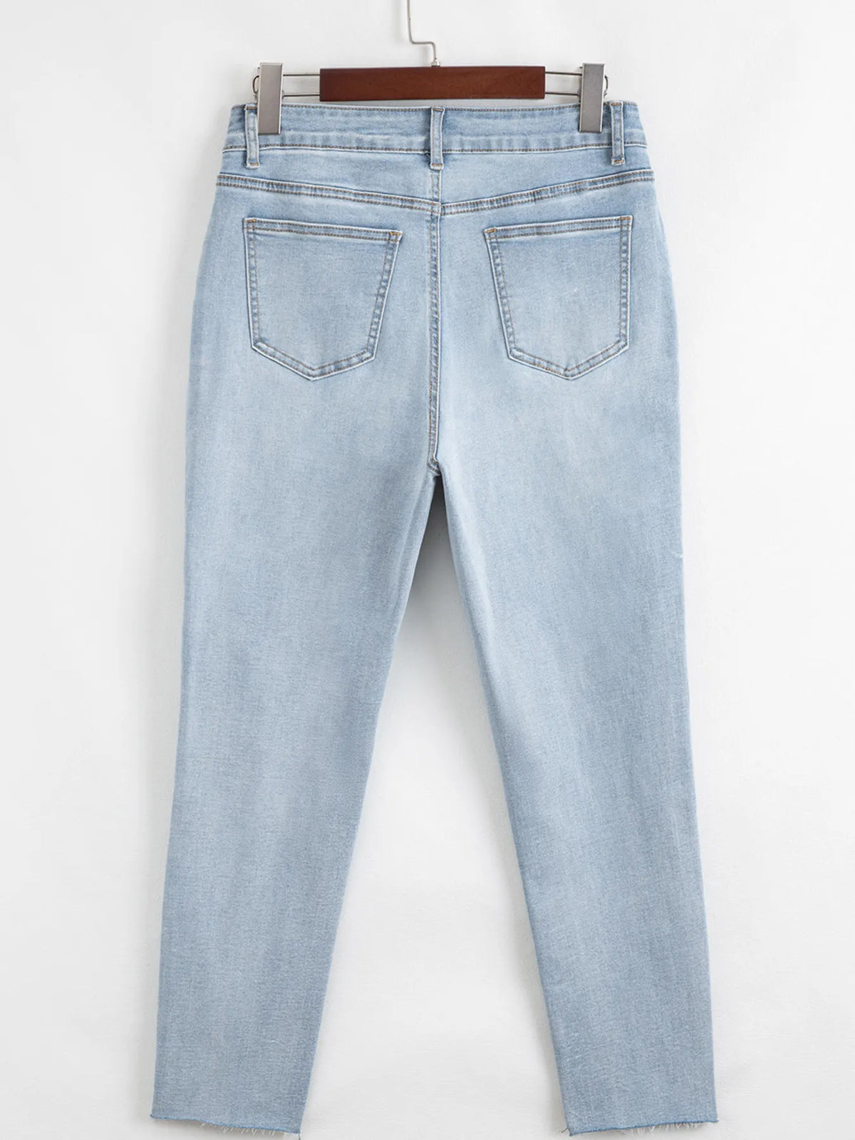 Distressed detail on light blue skinny jeans